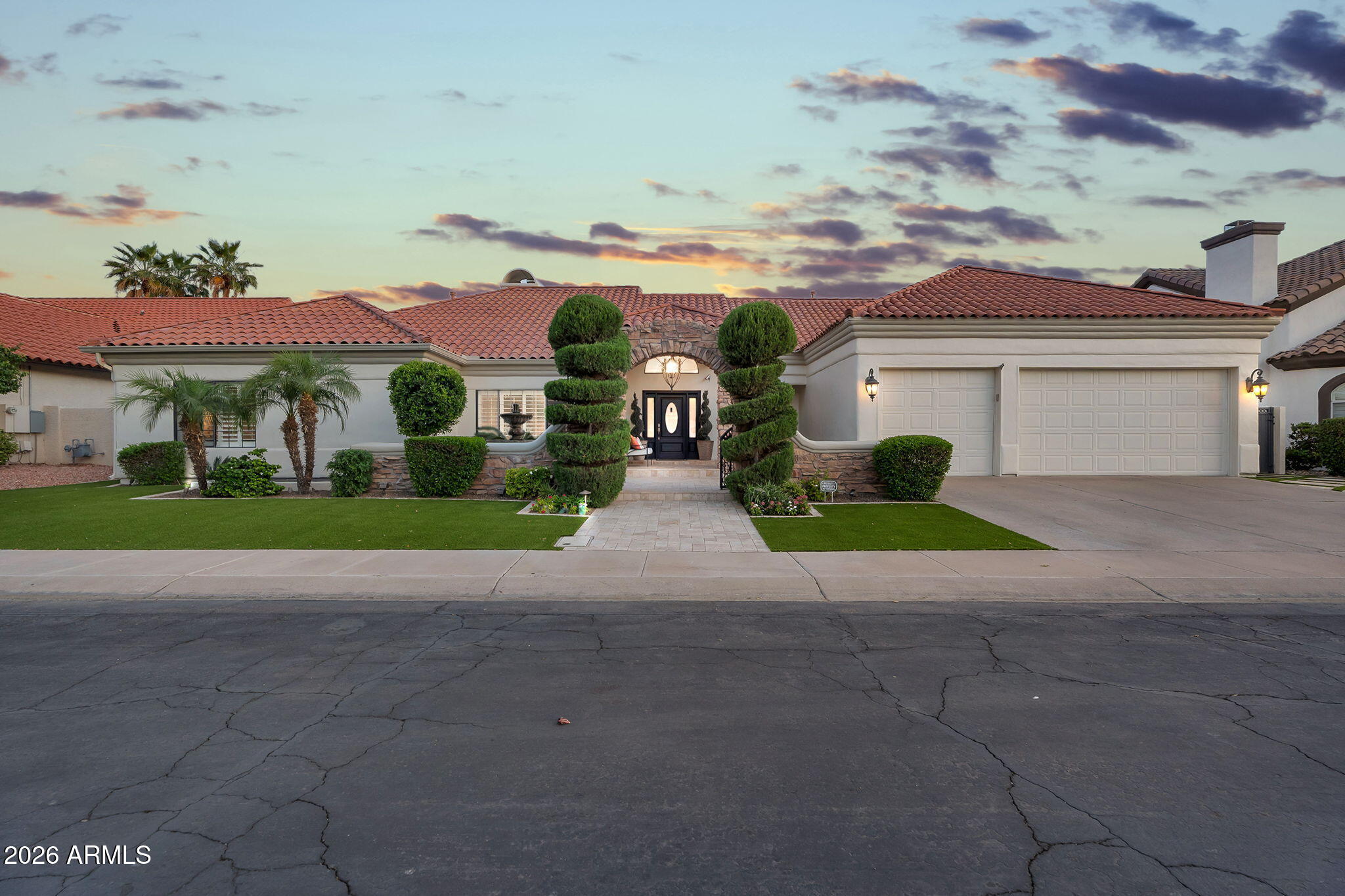 Nestled within the highly sought-after gated lake community of West Lake Estates in Gilbert, this exceptional 4-bedroom, 4-bathroom basement residence offers a rare blend of luxury, warmth, and thoughtful design. From the moment you enter through the gated travertine and stone courtyard, framed by lush mature landscaping and newly installed low-maintenance turf, the home invites you into a setting that feels both elegant and serene.
Inside, a spacious open floor plan showcases upgraded flooring, coffered ceilings, custom stone pillars, a statement fireplace, and rich wooden plantation shutters, creating a refined and inviting atmosphere throughout. The split primary retreat is a true private sanctuary, featuring direct patio access, a custom walk-in closet system, and a beautifully... upgraded spa-inspired bath complete with a 10-jet walk-in shower, soaking tub, dual vanities with premium hardware, and porcelain tile flooring.

Additional main-floor bedrooms are equally impressive, including an oversized walk-in closet and a fully remodeled Jack and Jill bath designed with a separate walk-in shower, stand-alone soaking tub, intricate tile detailing, and split vanities topped with Carrera marble. At the heart of the home, the chef's kitchen is appointed with a custom island, stainless steel double oven appliance package, built-in refrigerator/freezer, pantry, and French doors leading to a charming greenhouse atrium.

Privately situated at the rear of the home, a versatile bonus room offers the perfect space for a guest suite, fitness studio, or flex living area, adjacent to a fully remodeled 3/4 bath with direct access to the travertine-covered patio and sparkling saltwater pool. The backyard continues to impress with an RV gate and a large sunken concrete parking pad designed for discreet private storage below the cinder block wall.

One of the home's most distinctive features is the rare Arizona basement, filled with natural light and thoughtfully designed to function as a complete secondary living quarters with an additional primary bedroom and bath, kitchenette with wet bar and sink, fireplace, and expansive living space ideal for entertaining, multigenerational living, or a private kids' retreat.

Additional upgrades include first-floor indoor laundry, an office/den, a 4-car garage with built-in storage and new garage door opener, soft water system, newer HVAC with warranty, tankless water heater, and full exterior paint completed in 2026. This is a home where every detail has been intentionally curated to impress - get your private tour today to fully experience this exceptional home in person.