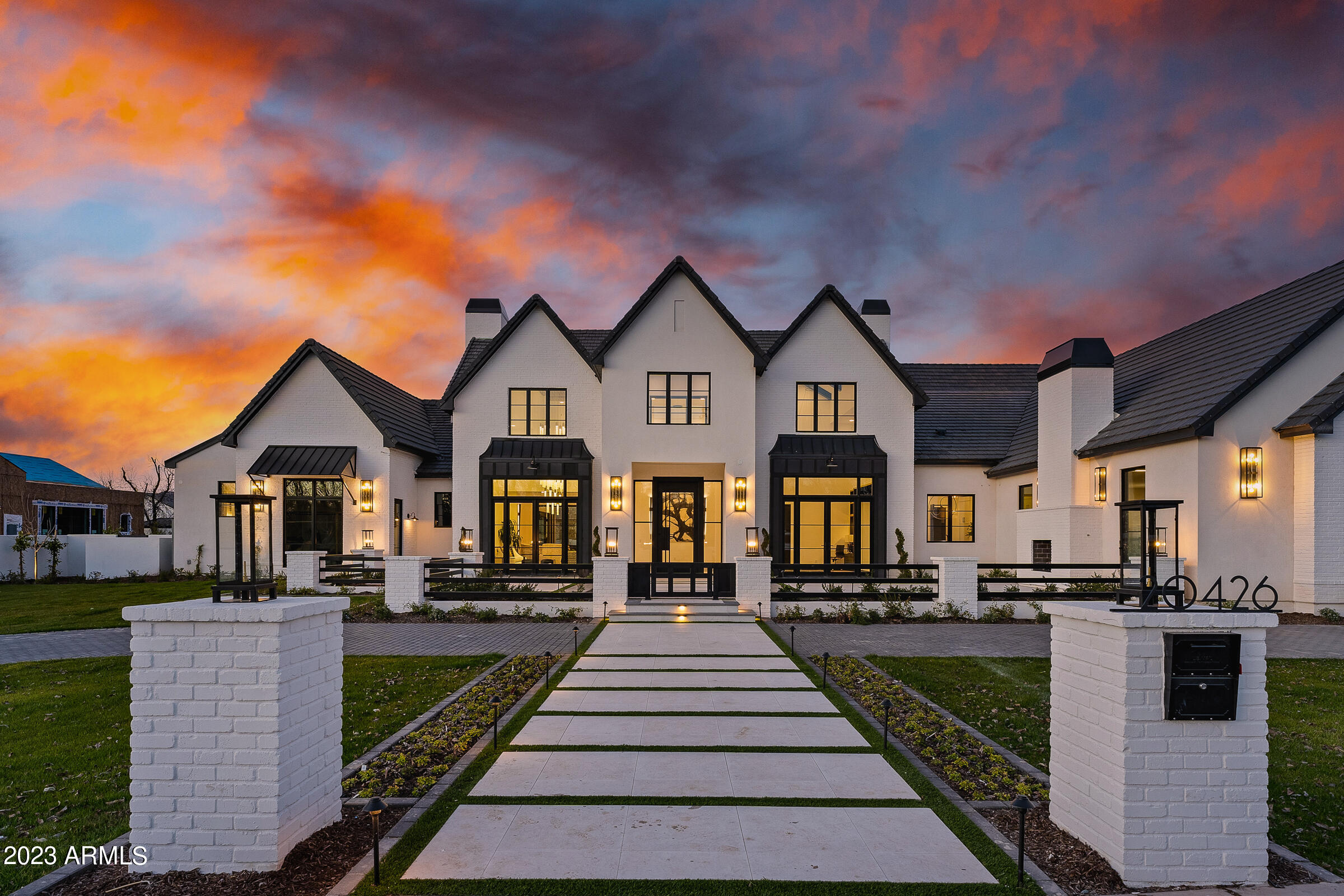 This modern custom home, built by E&A Custom Homes, presents a rare opportunity to live in a woodland paradise in the desert. Mature trees and landscaping, and a sprawling lawn welcome you to this one of a kind estate. This 7,864 sq ft Pecan Lights estate has four bedrooms, all with en-suite bathrooms, and two additional half bathrooms. Inside the glass and iron front door, you are greeted by the soaring ceilings of the grand foyer that is flanked by a built-in, saltwater fish tank and a dramatic, temperature controlled glass wine cellar. Just off the entryway is a home office that overlooks the custom courtyard, professionally designed and landscaped by Sherwood Outdoors. A large formal dining room, with stunning custom lighting and double doors opening to the courtyard can be found opposite the home office. The great room has fireplace completed with solid marble slabs and coffered ceiling. The kitchen, which opens to the great room is perfect for entertaining. It features double islands with waterfall edge countertops and Wolf appliances. If you've ever dreamed about entertaining while having an immaculate kitchen, this home also has a full prep kitchen. Additional entertaining spaces include a home theater and gameroom. The backyard has a 50 ft pool with diving board and jumping platform, and a 15 ft water wall adjacent to a firepit, and artificial turf. Wood flooring runs throughout the home and the windows a finished with automatic shades. There is a four car garage, plus an air conditioned RV garage.

Living at The Pecans affords a completely different experience from typical Arizona communities. Come home to canopied boulevards with wide, tree-lined medians fronted by custom homes. The community is alive with parks, playgrounds, splash pad, a putting green, and miles of walking and biking trails. And everywhere there's the splendor of the trees with their cooling shade, lush foliage and ever-changing colors. The Pecans is referred to as an Arizona surprise because a feeling of unexpected wonder is the reaction from everyone who is introduced to this extraordinary property. For the past 30 years The Pecans has been a working grove with thousands of mature pecan trees. In this enchanting environment, is a custom estate community with just 258 Queen Creek Home sites.