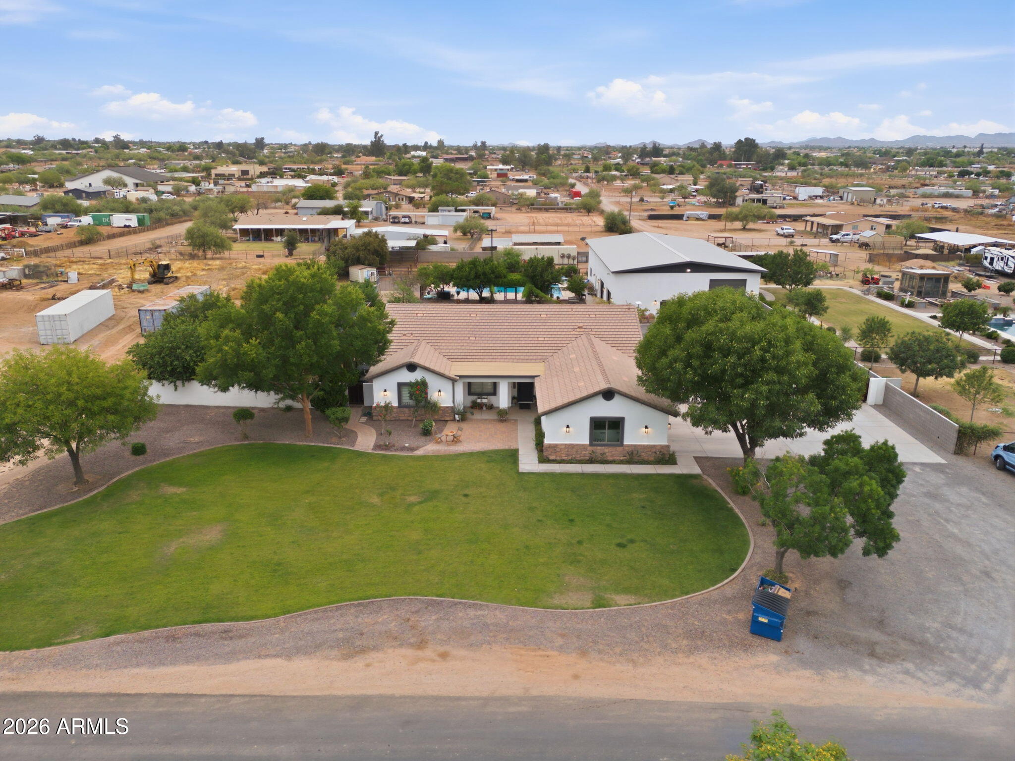 Need space for your toys, your people... and a little distance from the neighbors? This one checks every box and MORE. Sitting on 1.25 acres in San Tan Valley, just south of the new AZ 24, this fully updated property features a 2,450 SF main home with 5 bedrooms, 3 bathrooms, and an open-concept layout built for entertaining inside and out. 
Out back, a huge covered patio, mature shade trees, lush grass, over 30 fruit trees, raised garden beds, a diving pool with custom steel fencing and room for your mini farm! The detached garage will blow your mind, it has a 3,680SF footprint, two 16 foot RV garage doors with a full pass-through, two 10 foot glass garage door, a half bathroom and access to an 1800SF guest house.... The guest house with a full kitchen with a walk in pantry, private primary suite downstairs, and a massive flex space with another full bathroom upstairs. You won't find another home like this, so come make it yours.