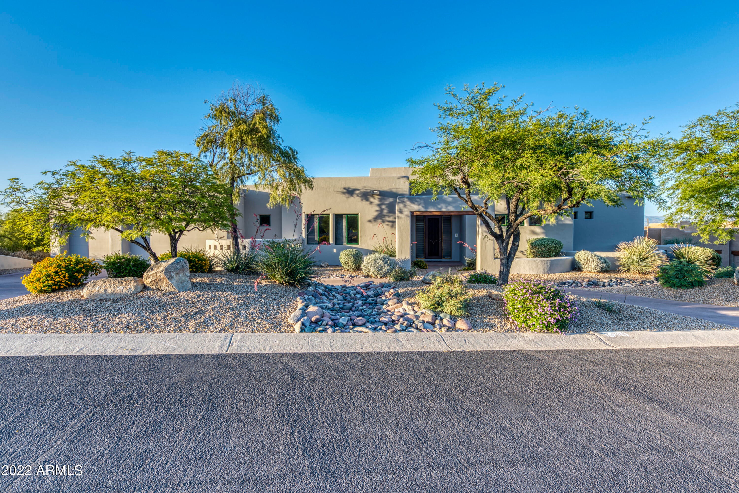 Nestled on one of Fountain Hills' most coveted streets, this home is certain to impress! Enjoy single level living in this brilliantly crafted masterpiece. The adorned North/South orientation showcases Superstition Mountains, Weavers Needle, Red Rock and the Fountain of Fountain Hills from the front and truly stunning, unimpeded, panoramic view ranging from the McDowell Mountains to the 4-Peaks Mountains of Arizona from the back.  This incredible territorial estate offers 3200+ square feet of pure excellence, a highly desirable open concept floor-plan, 5 bedrooms, 3 ½ baths, solid core alder doors and cabinetry, and soaring 12' & 10' ceilings found throughout. Open to the window lined living room, the spacious gourmet kitchen features granite countertops, stainless steel refrigerator, walk-in pantry, dual ovens, island with cooktop, and dining nook. Compelling rejuvenation, the spacious master is a true retreat with plenty of natural lighting, private backyard access, dual vanities, walk in shower, and impressive walk-in closet. Enjoy any Season from the backyard oasis complete with a large rear covered back porch (516 sq. ft.), unattached Ramada with fireplace and barbecue (153 sq. ft.), sparkling infinity pool, and a tranquil spillover spa. Notable features of this home include rounded edge (bullnose) concrete block construction yielding a pleasing "soft line" appearance. Extensive pre-wired security system. Network cabling is client / server future proof wiring consisting of dual fiber, dual RG6, and Cat5 bundles throughout.