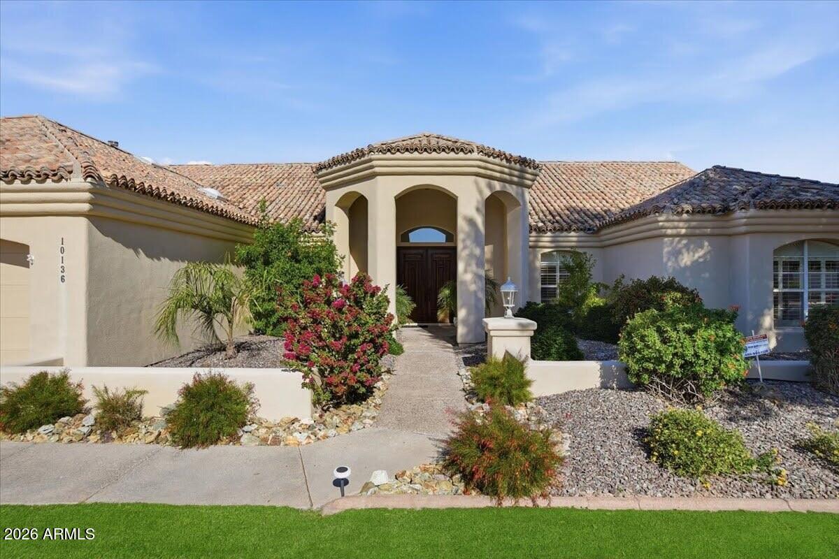 Welcome to refined living with a blend of charm and Arizona character. Grassy front yard and 3-car garage. Inside you have architectural charm, while a blend of carpet and tile flooring, new interior paint and wonderful raised vaulted ceilings. The great room has charming backyard views, while the family room features a cozy fireplace, media niche, and wet bar. Chef's eat-in kitchen showcases an island for prep and a breakfast bar, granite counters, SS appliances, a walk-in pantry, staggered cabinets with crown moulding, and a striking dark backsplash. The primary bedroom offers a fireplace, direct backyard access, and a spa-like bathroom with an L-shaped vanity. Homes like don't come up often. View today!