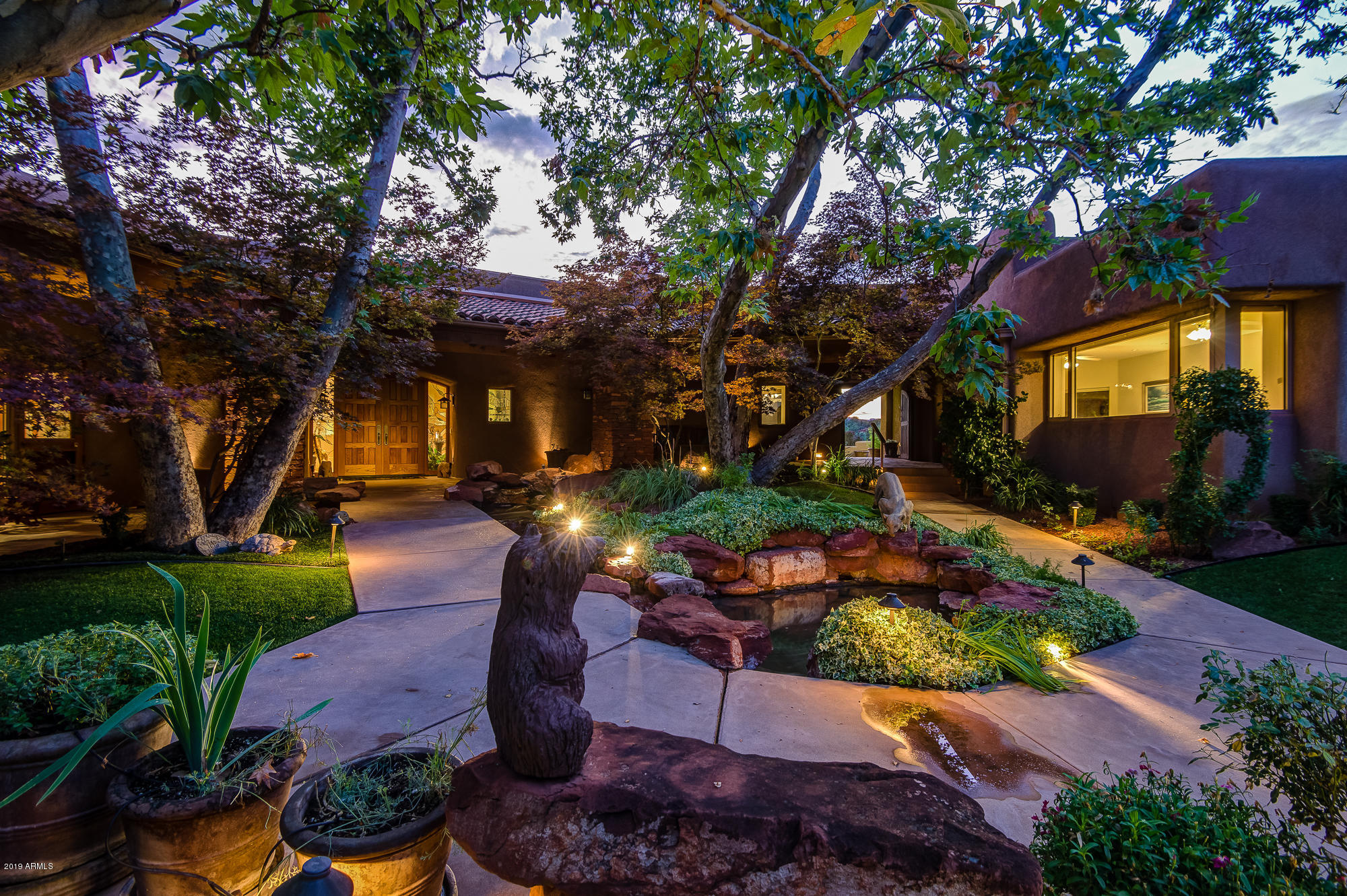 NEW PRICE to include 30 Veritas for a total of 15.69 Acres. Uninterrupted RED ROCK VIEWS and PRIVACY. NO HOA for the 14.07 acres. Estate designed by renowned architect Don Woods. It's ideal for large/extended family living OR as a corporate/executive retreat location offering wide-ranging, desirable ammenities, & high quality construction. Lavish, comfortable, meditative, contemplative and relaxing, and motivational spaces accommodate day or evening, casual or formal activities. Enjoy stunning 360-degree RED ROCK views from the spacious master suite, sumptuous library or offices and indoor pool. Estate includes main and guest-houses, and convenient live-in staff quarters.Potential for building a separate collector car garage, vineyard, or horse facilities. WOW! -All ONE Level
-Panoramic views of Bell Rock, Courthouse Butte, Lee Mountain
-Neutral Venetian Plaster in Main House
-Gated Property 
-Entry Courtyard boasts Sycamore Trees, meticulous landscaping and water to delight the senses
-Tongue and Groove Wood Ceilings accented by Ponderosa Viga Beams
-Indoor swimming pool with pool bath
-7911 Sq Ft Main house features 2 Split Masters, His and Her Offices, Gym, Great Room, Library
-Guest house offers 1717sq ft with 2 bdrm, 2 bth , full kitchen, living room, dining space, and can sleep 11 comfortably, stackable washer and dryer
-Maid Quarters is 497 sq ft &  features a kitchenette, living room & bedroom combination, and full bath
-Master Chef Kitchen w/ fireplace: Side by Side SubZero Refrigerator and Freezer, Indoor BBQ, Cooktops feature both Electric and Gas cooking, Double ovens, warming drawer, Wok Station, granite slab countertops, curved island bar seats 8, two sinks, microwave, eat-in nook, desk area, and a FULL WORKING Pantry for Storage and Entertaining
-Formal Dining Room is adorned by both a jade granite buffet w/ built-in china cabinet AND separate jade granite bar with a gold sink and wine fridge  w/ built-in cabinets for glass storage
-Library maximizes comfort with cherry floors and built in bookcases for your favorite collections
-Main Master Retreat offers exquisite views, private patio, fireplace, wetbarw / fridge and microwave , female vanity with rose colored lighting for amazing makeup, Asko Washer and Dryer, Two Walk In closets, bidet, steam shower with 4 heads, 3 person jetted tub
-Lush green grass at North Yard and West Yard
-Raised Planters for a Full Garden
-Private Pergola to take in views
-Covered Outdoor Patio and Covered Breezeways to access the maids quarters and quest house
-Built-In BBQ and outdoor counter space for huge events
-Multiple open patios