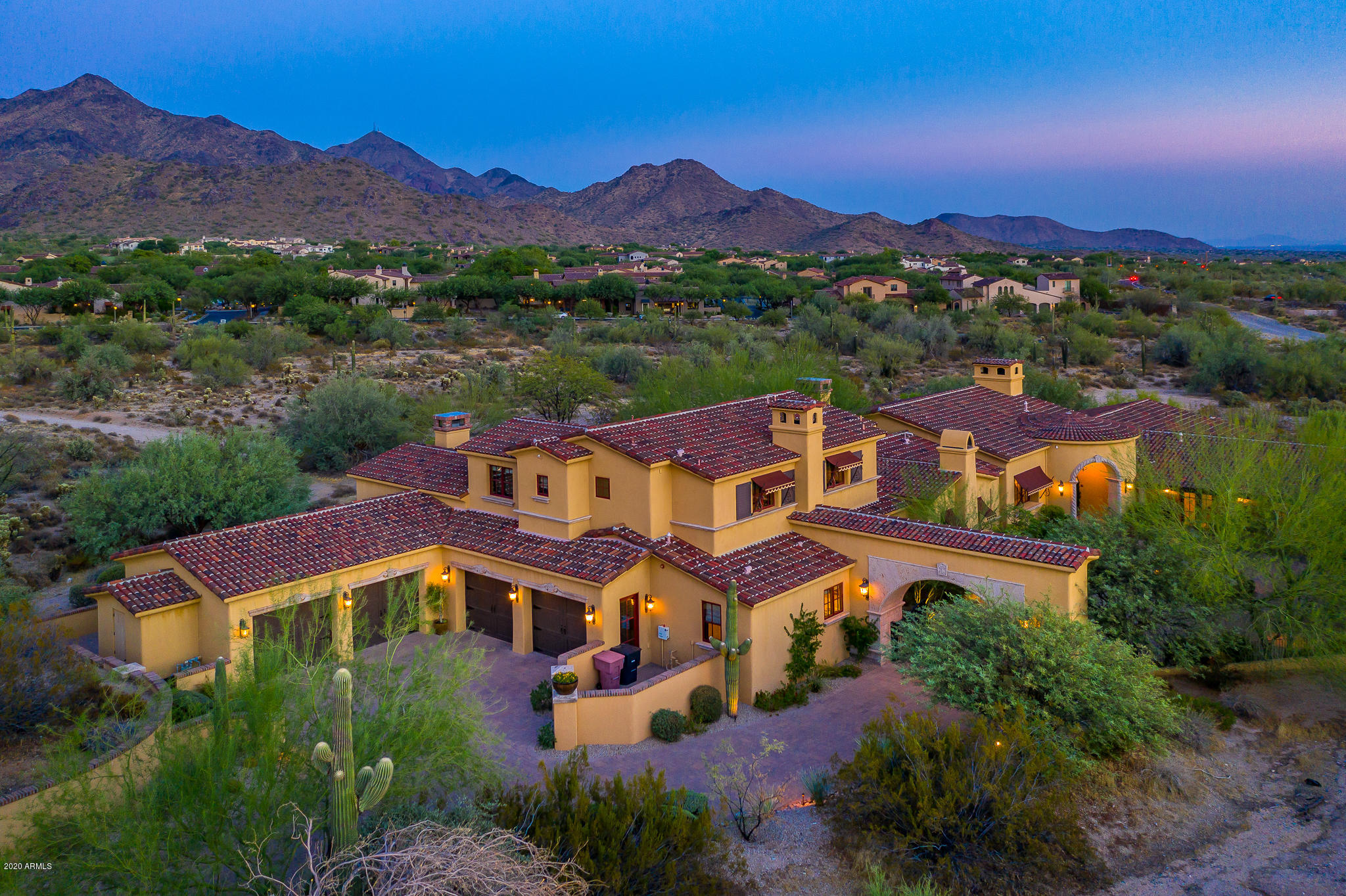 Privately gated Santa Barbara/Spanish Estate in DC Ranch!  This 7054 sf Bing Hu-designed masterpiece is inspiring both inside and out.  Set on over 1.24 acres and bordering a large wash, unobstructed McDowell Mtn views can be enjoyed from nearly every room in this distinctive home. A dramatic entry awaits, which includes a stone clad porte-cochere with a private gate and a circular auto-court anchored by a grand fountain.  A desirable floorplan features significant main level living: Master Suite with sitting room & private courtyard, executive office suite, media room/exercise room and a separate entry guest house. Kitchen flows nicely into the breakfast nook and family room, while living room features a handsome built-in bar area with access to outdoor spaces via pocket doors. Two guest suites and bonus room with access to view deck are on the second floor. An expansive backyard includes a lap-pool, spa, multiple fire features, two stand alone fireplaces, large turf area, a trellis patio area, a BBQ center, and significant covered patio spaces all capturing sweeping mountain views to the east in this private setting. Elegant features found throughout include designer kitchen amenities, walk-in wine room, coffee bar and separate washer/dryer in master suite, central vac, hand-carved risers on steps, brick and wood beam ceilings, Savant home automation system, extensive stone and wood flooring, and 4 car garage with built in cabinetry and temperature-controlled storage room.  Great location in DC Ranch, conveniently located across from one of the community's many parks and adjacent to the path and trail system that runs through the neighborhood.  Property also has easy access to the guard gate and to the amenities of DC Ranch which include the Desert Camp Community Center, Copper Ridge K-8 school, and the shops/dining at Market Street.