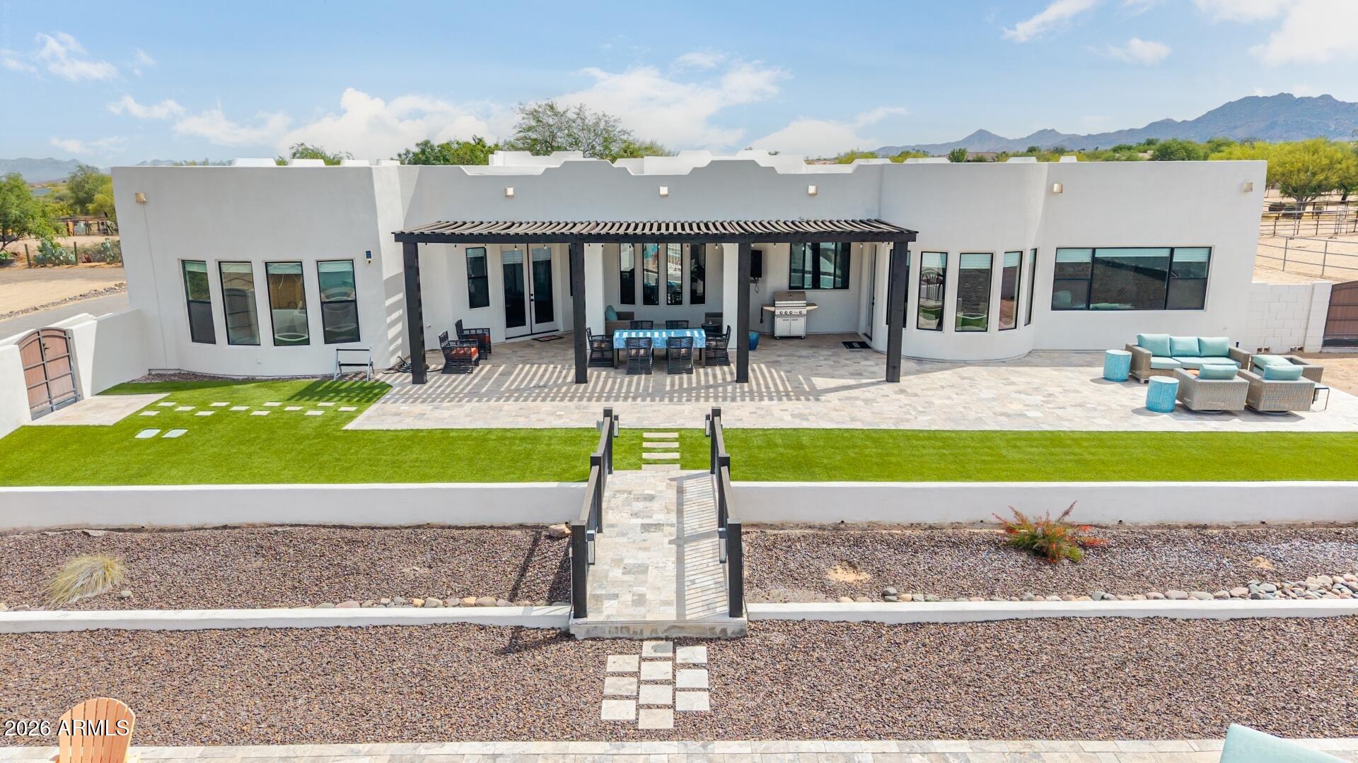 Turnkey luxury residence in North Scottsdale on a 1-acre lot. This custom home was fully remodeled inside and out, including a new roof, completed fall 2025. The 3,640 sq. ft. layout includes 4 bedrooms and a dedicated office, with fresh interior and exterior paint, new tile flooring, updated cabinetry and storage, and new energy-efficient lighting and fixtures. The remodeled chef's kitchen features an oversized quartz island and countertops, upgraded refrigerator and dishwasher, a Bosch induction cooktop, and double ovens with integrated microwave. Additional updates include remodeled bathrooms, a new R/O system, water softener, and water heater. Highlights also include a dry bar with wine rack and wine refrigerator, and a redesigned fireplace in the living room. The primary suite includes a fireplace, private sitting area, and an ensuite bath with custom walk-in shower, separate soaking tub, and an oversized closet. The sitting area includes a workout area/media room, additional storage, and a beverage refrigerator. Before 2025, the yard was developed into a backyard oasis with an oversized pool and Baja shelf, walls, bridges, and landscaping, plus two long driveways for RV parking and additional vehicles. A secondary backyard entrance leads to a manicured area with a fully tiled patio, pergola, and multiple seating areas.