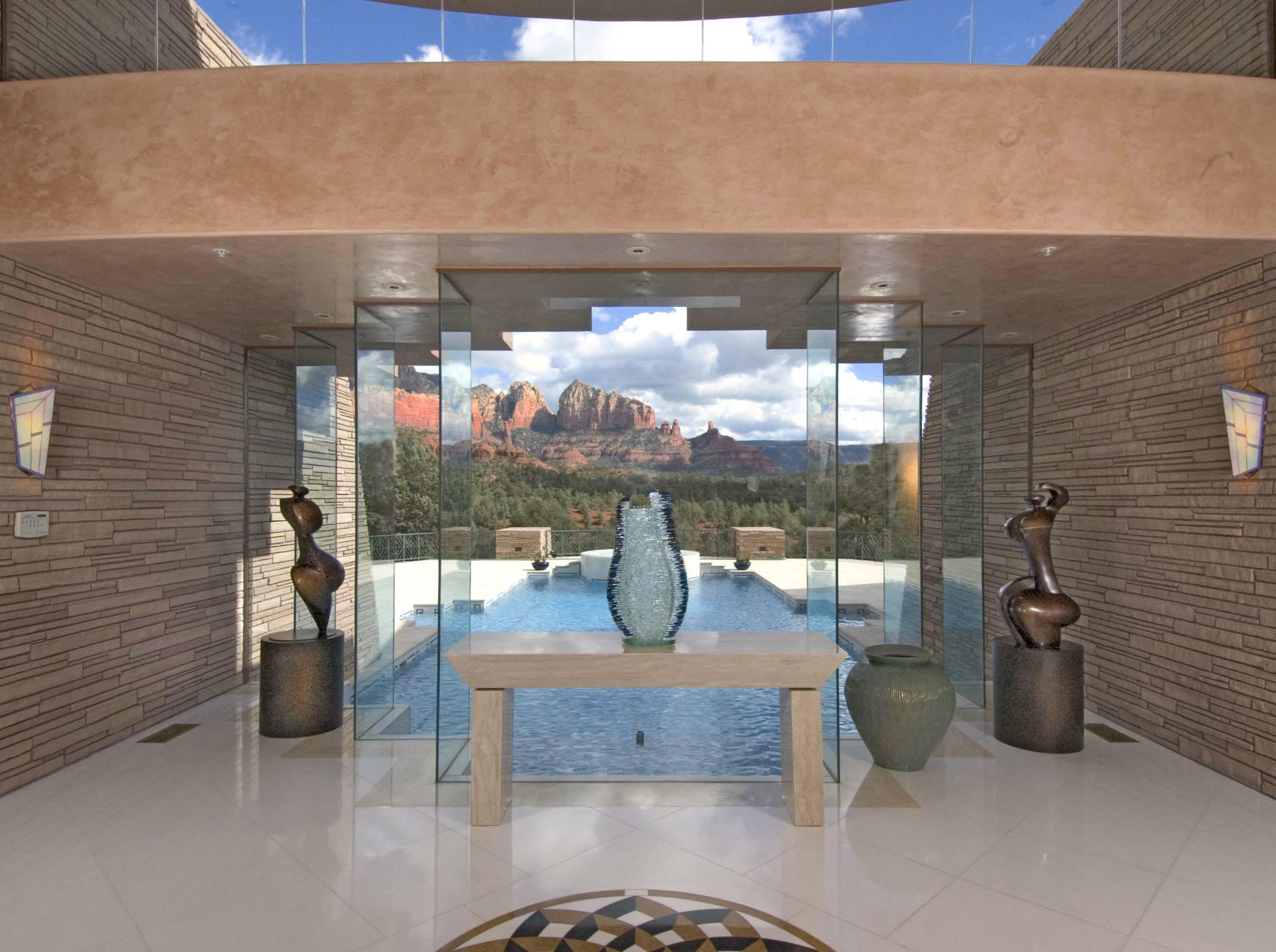 This elegant estate is a celebration of luxury, color, shape and form. Ingenuity of design and the best building materials available are played out in a crescent moon shaped home that captures Sedona's world famous red rocks, forests and sunsets. Expansive windows bring the outdoors & indoors together in seamless perfection. The home is on 8 acres bordering the Coconino National Forest. Enjoy over 9,000 square feet of luxury living with five suites, a grand foyer, great room, dining room, gourmet kitchen, office/media room, detached gym and pool/spa. Each room showcases luxurious materials including white Thassos marble & Italian travertine; onyx countertops, fireplace mantels & inlays; exotic granite countertops; imported Ming Green & Norwegian marble... (see supplement for full remarks) This elegant estate is a celebration of luxury, color, shape and form. Ingenuity of design and the best building materials available are played out in a crescent moon shaped home that captures Sedona's world famous red rocks, forests and sunsets. Expansive windows bring the outdoors & indoors together in seamless perfection. The home is on 8 acres bordering the Coconino National Forest. Enjoy over 9,000 square feet of luxury living with five suites, a grand foyer, great room, dining room, gourmet kitchen, office/media room, detached gym and pool/spa. Each room showcases luxurious materials including white Thassos marble & Italian travertine; onyx countertops, fireplace mantels & inlays; exotic granite countertops; imported Ming Green & Norwegian marble; Venetian Plaster; Bizzaza tiles; finely crafted custom doors/windows/cabinetry; stainless steel appliances & enameled cabinets in the Kitchen; & stain glass.

The List of Features, Plat Map, Floor Plan, List of Personal Property Included/Excluded in the Sale and Sedona Homes & Garden Magazine Article are in the Attached Documents.