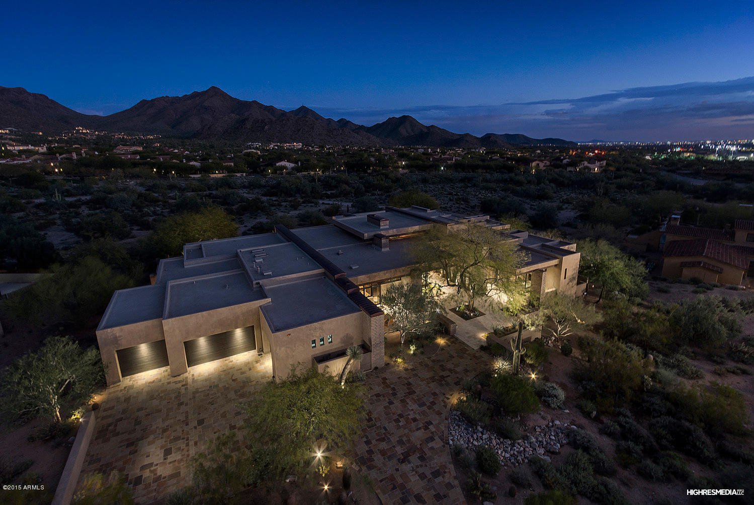 Elegant modern design built by Tom Archer Custom Homes situated on a 1+ acre private lot with sweeping mountain and city light views.  This home features a beautiful open floor plan with walls of glass, custom doors and Fleetwood windows stretching from floor to ceiling. Extensive use of Adobe brick and very fine appointments throughout. First class amenities include a home theater with state of the art equipment; office/den with wet bar & custom bookshelves; secondary bedrooms en suite with private patio; master suite with exercise room & steam shower; casita with living room, kitchenette & private patio. Resort backyard includes expansive covered patio with 2 way fireplace for outdoor living, infinity pool, spa and outdoor kitchen.  Turn Key and comes completely furnished. MUST SEE!