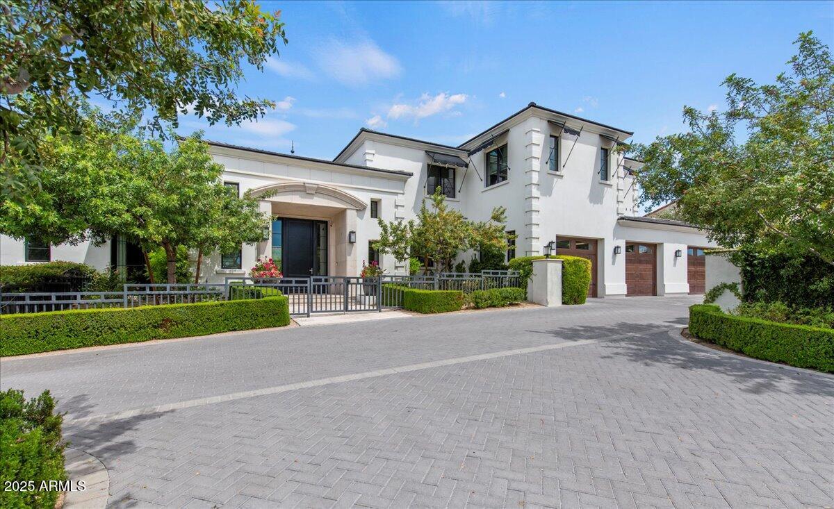 This fabulous estate property sits on a magnificent lot with exquisite views of Camelback Mountain. From the moment you arrive, you'll be struck by the impressive curb appeal, and once you enter through the beautiful foyer, you'll enjoy unique design and exceptional quality. The gourmet kitchen has a huge custom island that's a fantastic gathering space for family and friends with loads of room to prep, serve and entertain. The kitchen seamlessly flows to both formal and informal dining areas and into the huge great room where a lovely fireplace is the focal point of the open concept floor plan where retractable glass doors create flawless indoor/outdoor living. The private office is an impressive space for those who work from home, there's a second workspace great for the kids, and all the oversized bedrooms are terrific including a magnificent primary suite with a spa-like bath. The character of the home is highlighted by wide plank wood flooring, exposed wood beams, custom cabinetry, dramatic lighting, high end surfaces, and sleek bathroom design, and the highly manicured grounds feature an amazing outdoor living room, gorgeous pool and spa, custom ramada and full outdoor kitchen. This impeccable home is grand yet inviting, elegant yet comfortable, and calls for entertaining on any scale!