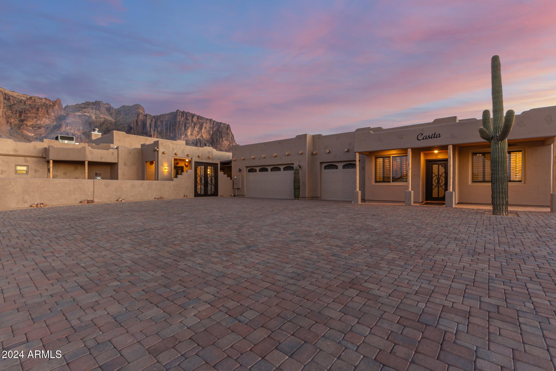 This is an outdoor lovers DREAM! This residence is nestled on an oversized 1 acre lot with FRONT ROW mountain views & featuring a natural desert landscape, AC units cooled& finished, 3 car garage, and extended paver driveway. Discover a spacious dining & living area w/elegant flooring, high ceilings, and exposed wood beams. The fabulous kitchen is comprised of soft close wood cabinetry & drawers, granite counters, a pantry, SS appliances, and an island with a breakfast bar. You'll love the primary bedroom, showcasing plantation shutters, outdoor access, a walk-in closet, and a lavish ensuite w/dual sinks. Guest quarters also boast their own kitchen! Lastly, the wonderful backyard includes a large covered patio w/a built-in BBQ, HUGE rooftop deck, and a pool/spa combo w/a rock waterfa