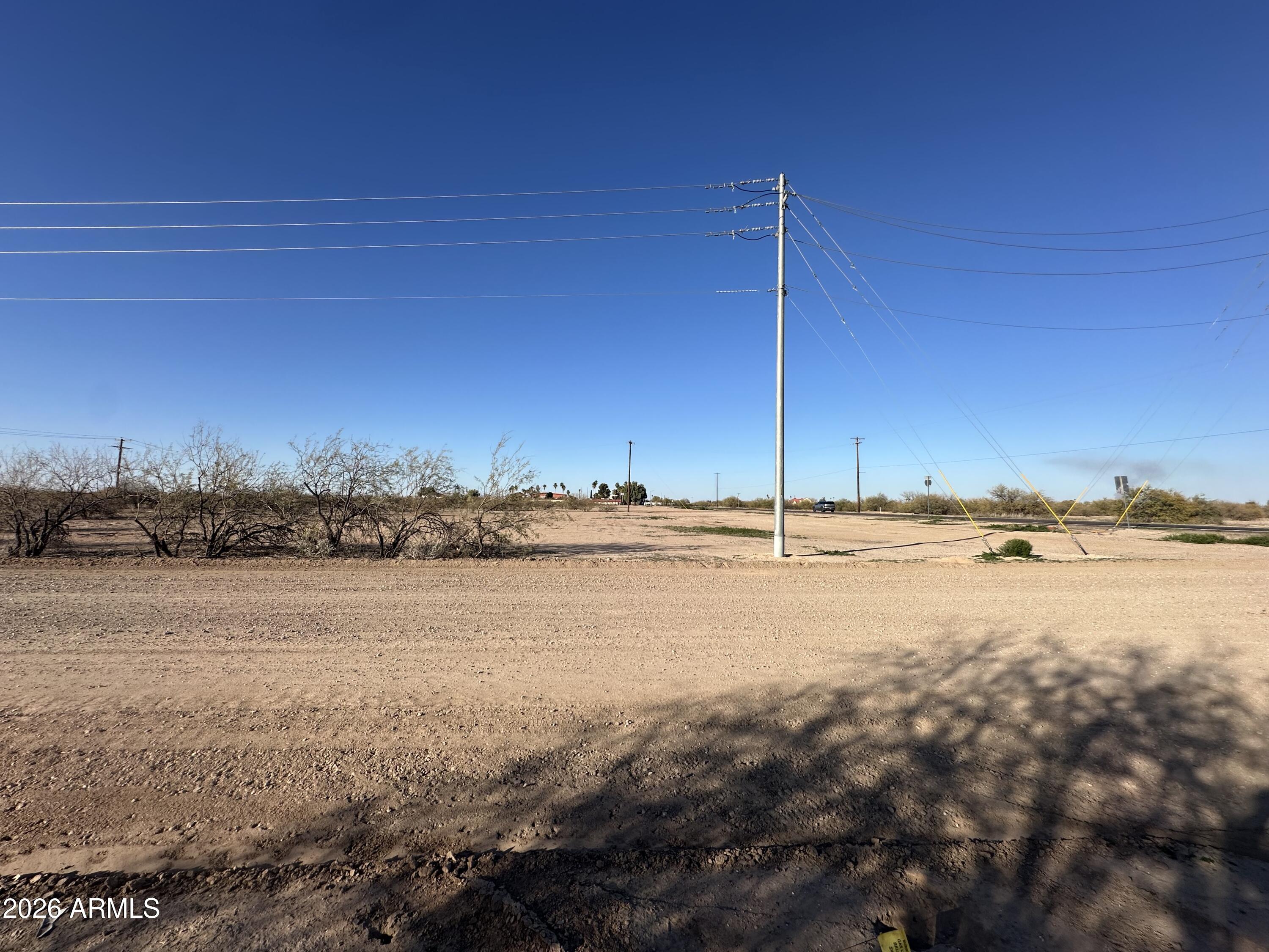 Great Views! Corner Lot. Commercial Property, Zoned C-2. Close to Toltec Elementary School, Restaurants, Hotels, Gas stations & Truck stops. Elementary & Jr. High School across the Street. City Of Eloy for water & trash services. APS for Electric. No Utilities to property. Water on Property line. Closest Fire Hydrant is 316 feet away. No sewer main nearby. Septic authorized. Once sewer lines are extended to area, property owner must connect to the City of Eloy sewer system and abandon septic. Close to Robson Ranch and Dollar General. Great Mountain views, Accessible to I-10 & I-8. Adjoining additional lots can be sold in one escrow. Lot 16 & 17 sold separately. See uses on Document tab.