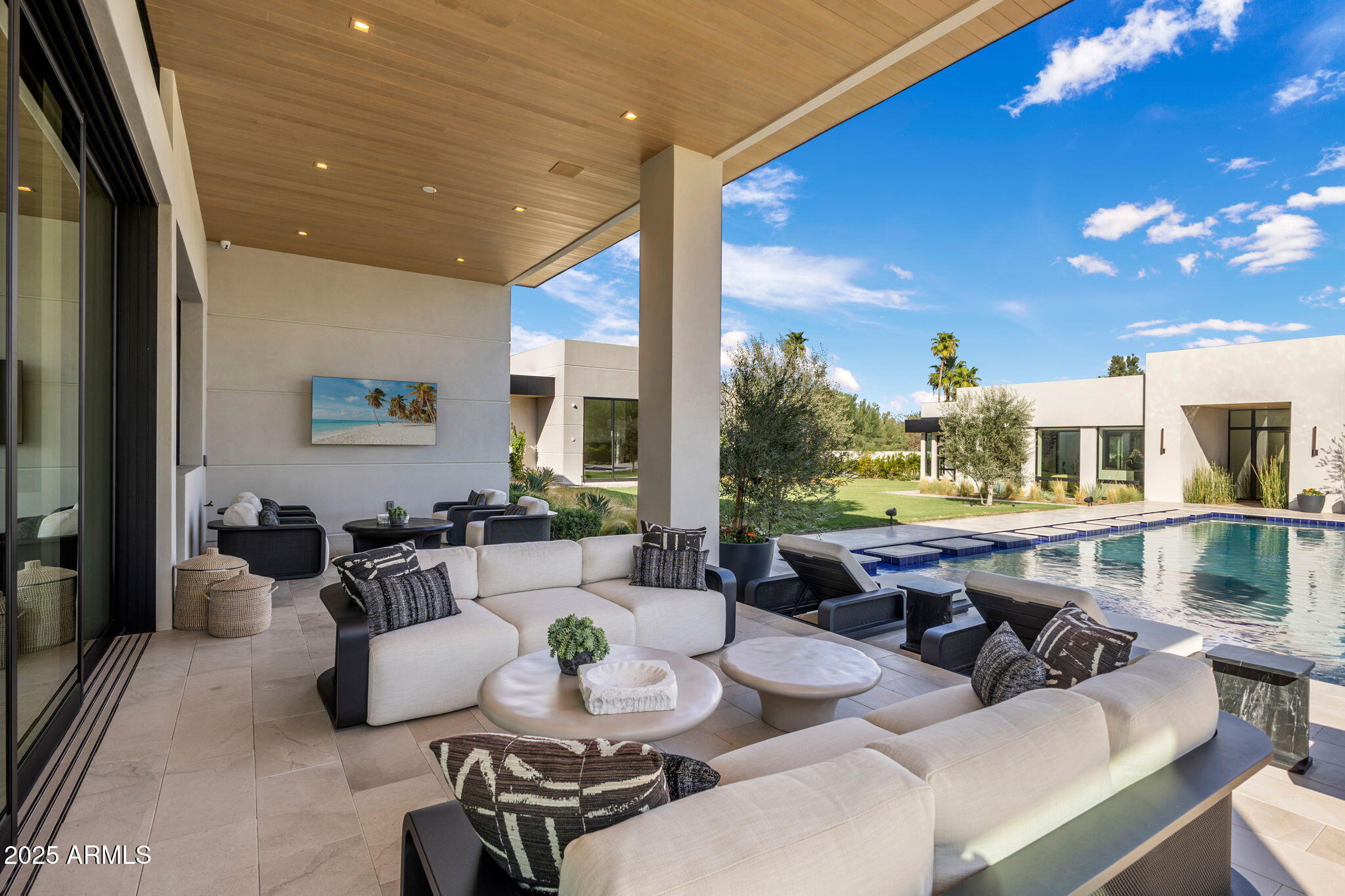 Wellness-Inspired Estate built in collaboration with the most respected design-build teams-Eagle Luxury Homes, Drewett Works, The Draftery, and Holly Wright Design. This contemporary estate blends luxury, craftsmanship, and high-end finishes. With 8,492 sq ft of living space and 11,718 sq ft under roof, the home is filled with natural light and seamless indoor-outdoor living with breathtaking Mummy Mountain views. Designed for entertaining, the main residence features 2 elegant primary suites with spa-like baths, an office, butler's pantry, stylish lounge, home theater. A separate guest house offers a private wellness retreat with an infrared sauna, steam room, cold plunge & gym. Resort-style outdoor spaces complete the property, located just a short walk from Cherokee Elementary School. the resort-style setting offers a pool, spa, meditation lawn mist system, full outdoor kitchen, and expansive patios with exceptional privacy. Molteni & C Dada closets. The home features a climate-controlled garage with A/C, humidifier, and full smart home systems. Privately gated, offering a heated saltwater pool and spa with lush landscaping.