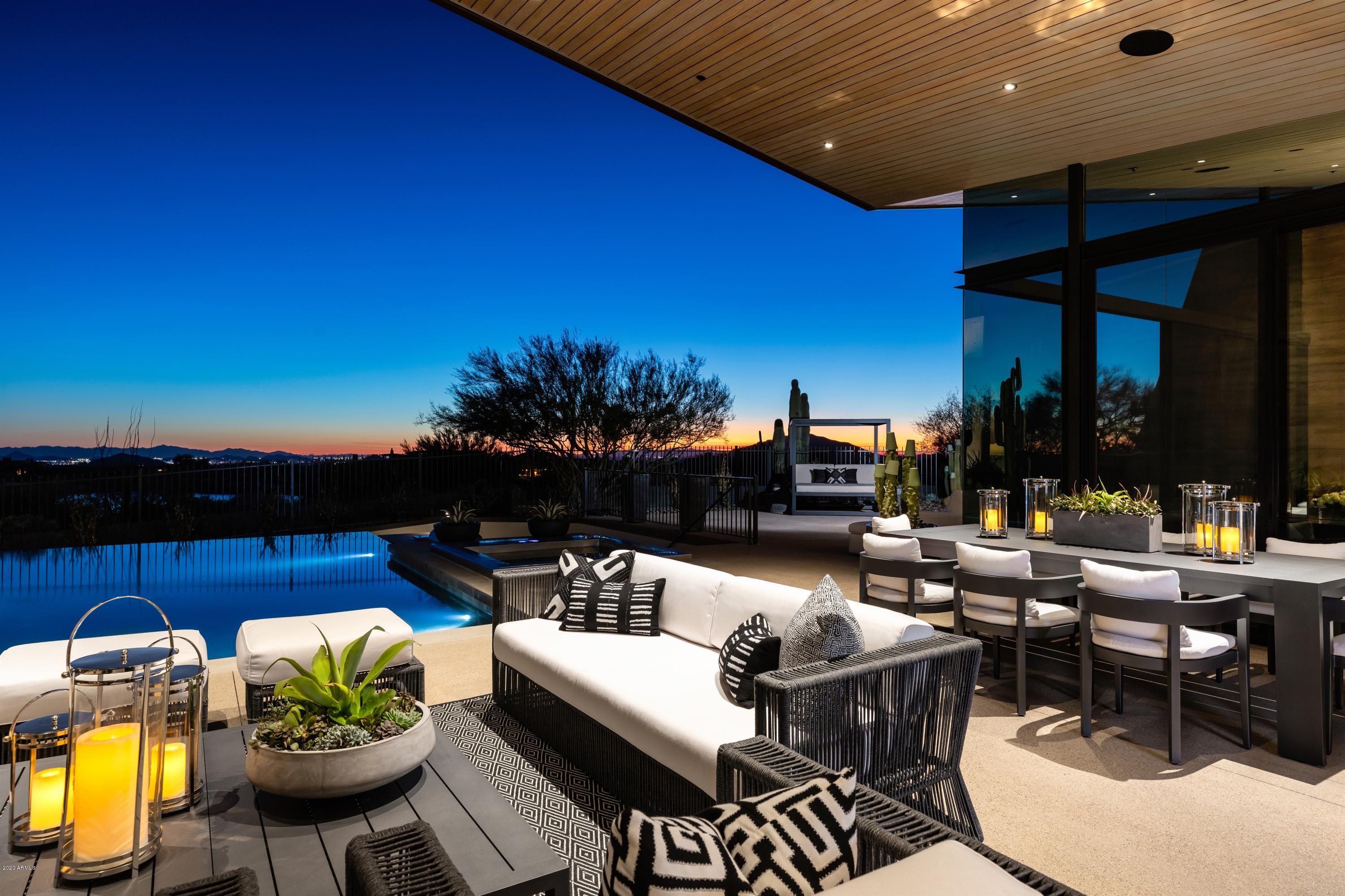 This timeless contemporary masterpiece...Desert Wing...blends a floating copper roof with organic rammed-earth wall construction delivering light and drama throughout! Designed by internationally published architect, Brent Kendle and built by world renowned Construction Zone. Located in the luxury golf community of Desert Mountain.Mesmerizing golf views give way to a panorama of mountains, sunsets and  city lights. Meticulous, recent renovation brings both smart-home technology and dazzling style from Pacific Dimension's Jill Mitchell.  Soaring ceilings and retractable glass walls seamlessly join the streamlined interiors with the private, resort-quality patios landscaped in a sophisticated succulent palette. Offered fully furnished and accessorized! Showing available January