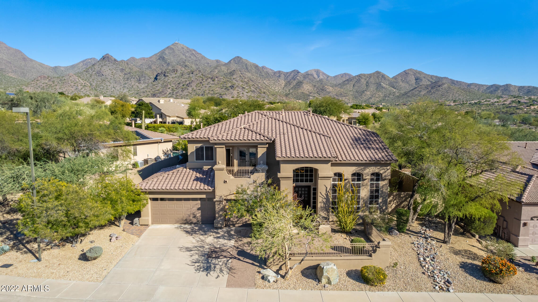 This beautiful home in popular McDowell Mountain Ranch sits on a private lot with spectacular views of the McDowell Mountains. Home features 5 bedrooms and 3 baths, with 1 of the bedrooms and a full bath downstairs. The open eat in kitchen has a walk-in pantry and an oversized island. The living and family rooms are spacious with high ceilings and large windows with lots of natural light. A gorgeous spiral staircase leads to the other 4 bedrooms and 2 baths. The primary bedroom has a private exit to the deck to access the amazing mountain views. Primary bath has his/her closets, walk in shower and a large soaking tub. Out back you will find a pool/spa with rock waterfall, flagstone decking, professional misting system, a natural gas bbq island, and low maintenance turf.  Come see today!