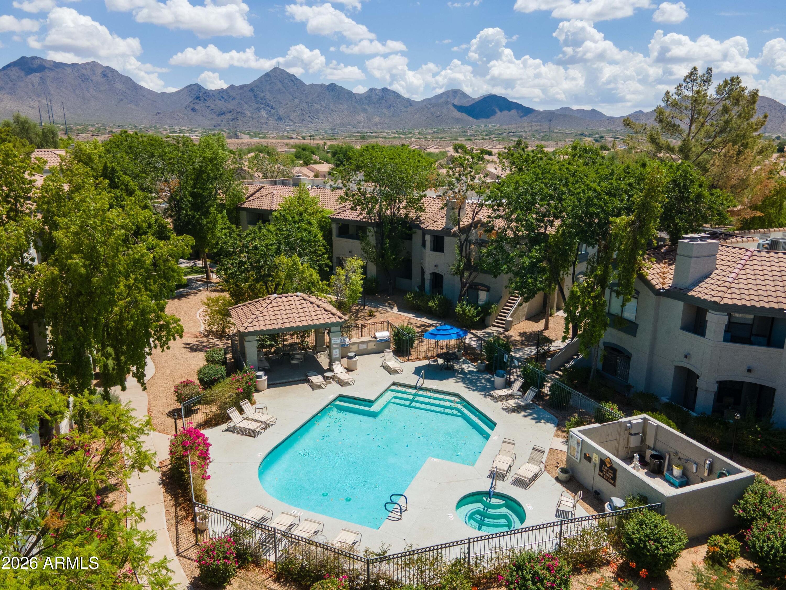Exquisitely remodeled jewel in the heart of N. Scottsdale. No restrictions for short term rentals. Discover effortless comfort in this beautiful ground-floor end unit, offering 2 spacious bedrooms and 2 fully remodeled baths. The open-concept design features a welcoming great room with a cozy fireplace, all with no carpet for easy maintenance. Both bedrooms include walk-in closets, providing ample storage. Enjoy brand-new HVAC, installed in August 2024, for year-round comfort. Nestled in a resort-style community, indulge in top-tier amenities: a clubhouse, pool, spa, BBQ area, firepit, fitness center, sauna, and steam room. Mountain views from the patiol This exceptional home offers style, convenience, and the perfect blend of relaxation and entertainment!