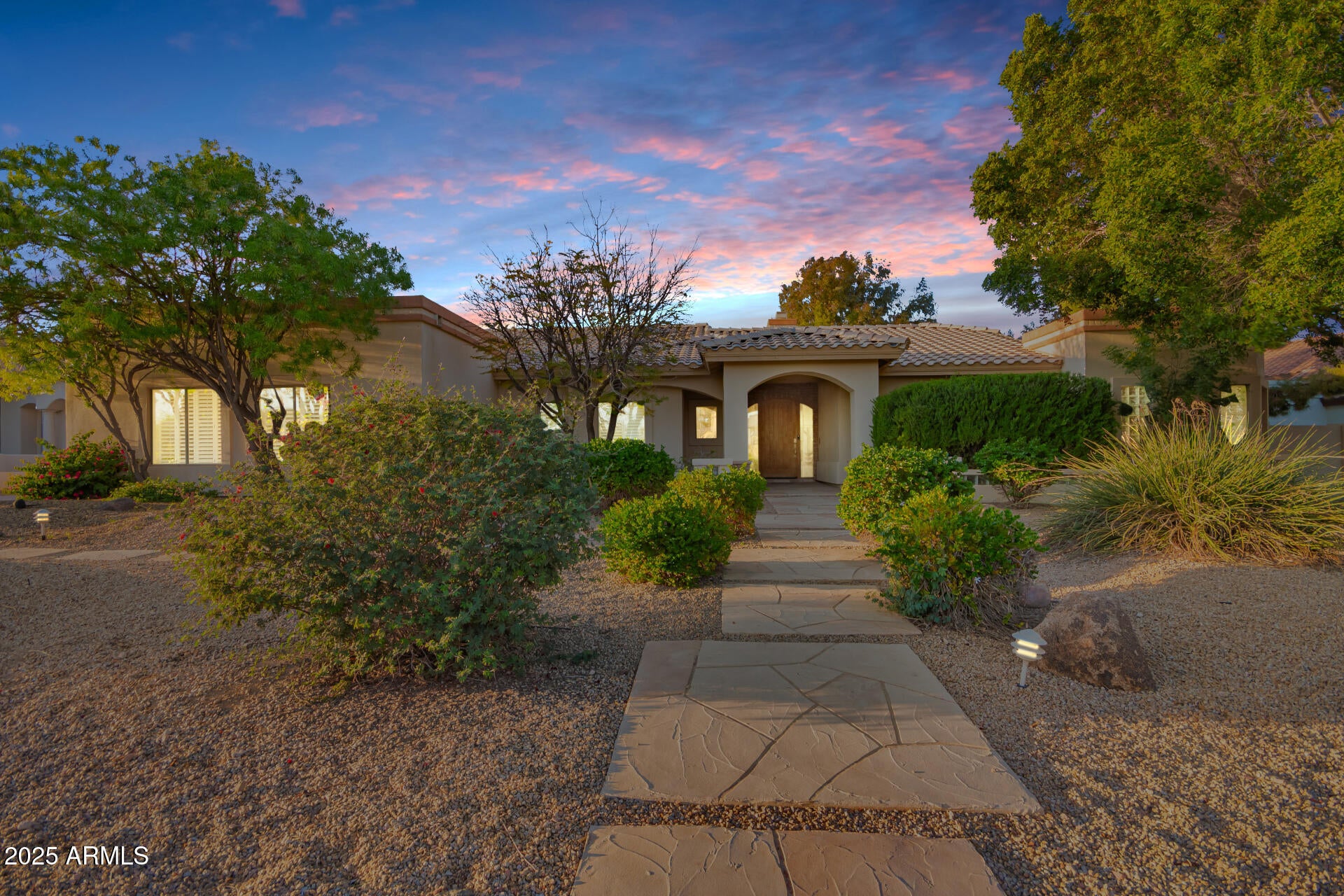 Nestled in the prestigious Ahwatukee Custom Estates, this stunning home sits on an expansive nearly half acre lot in a quiet cul-de-sac with no neighbors across the street, offering unmatched privacy and tranquility. As you enter, you're greeted by a grand foyer leading to a spacious living room with tongue and groove ceilings and breathtaking views of the backyard. A separate formal dining room adds a touch of sophistication, while the large chef's kitchen features granite countertops, a butler's pantry, and an open-concept design that flows seamlessly into the large family room.This home boasts two primary suites, each designed for ultimate relaxation. One suite is bathed in natural light, featuring an ensuite with a double vanity, a walk-in shower, and a luxurious soaker tub.The second suite opens to a private patio and offers its own spa-like ensuite with a double vanity, soaker tub, and walk-in shower. An additional office/bedroom upstairs provides extra convenience. Downstairs, you'll find two additional bedrooms, a full bathroom, and an abundance of storage. A spacious bonus room and family room with a spiral staircase leading to the backyard offer plenty of space for relaxation. The highlight of the lower level is the private movie theater, perfect for entertaining.

Step outside to your personal desert oasis! The resort-style backyard showcases a remodeled pool (2022) with travertine pavers, a sprawling grassy area, mature trees, and a built-in outdoor kitchen with a grill (2022). An RV gate adds extra convenience. The breathtaking mountain views and stunning Arizona sunsets create a serene retreat you'll never want to leave. Don't miss this rare opportunity to own a one-of-a-kind estate in one of Ahwatukee's most sought-after communities!
