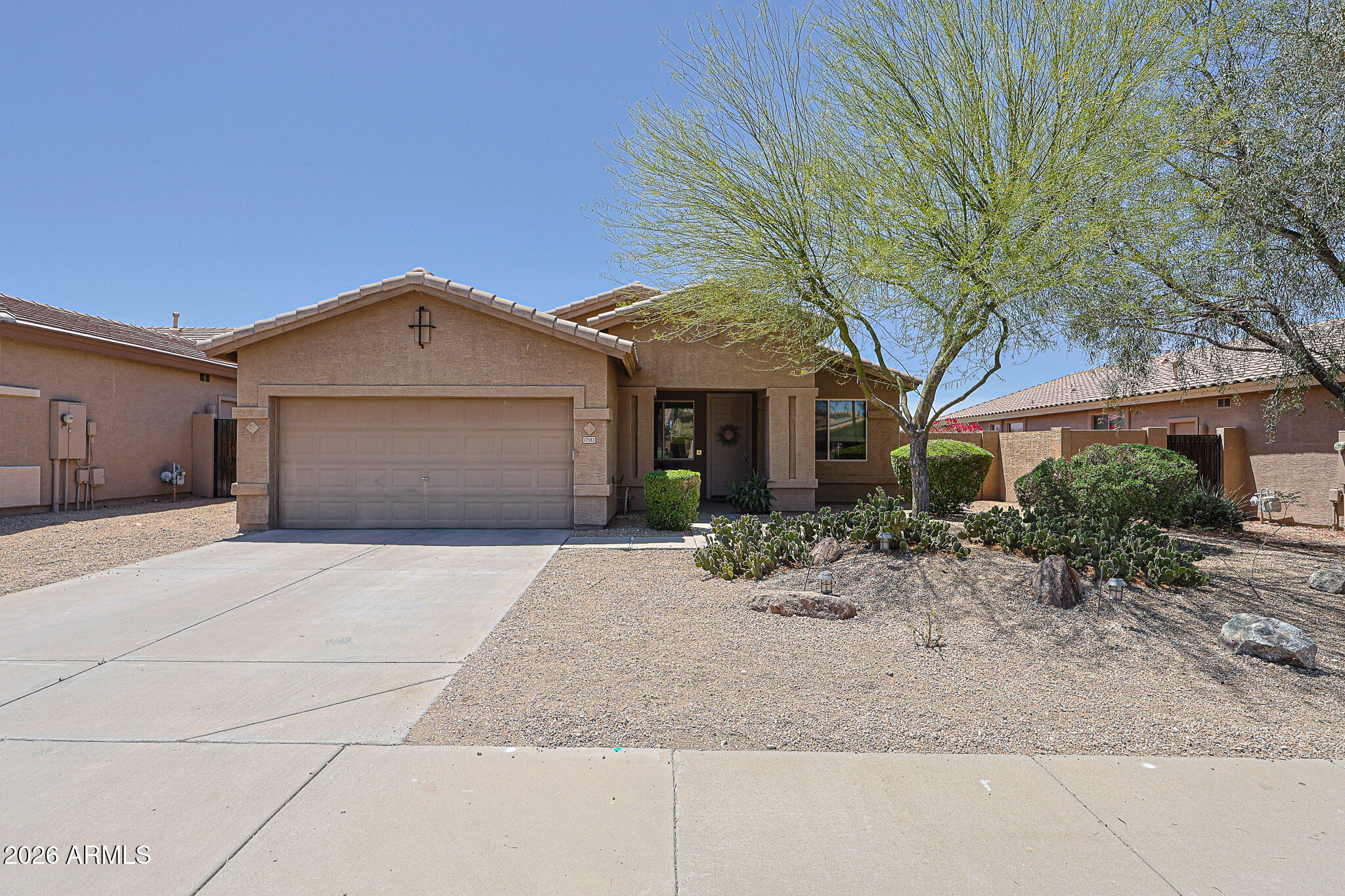 Welcome to a home that truly blends thoughtful design, everyday comfort, and effortless Arizona living. This beautifully upgraded 4-bedroom, 2-bath residence with a dedicated office/bonus room offers a flexible layout perfect for working from home, creative pursuits, or simply spreading out and enjoying your space. From the moment you step inside, you'll notice the light-filled interior enhanced by solar tubes, upgraded windows, and consistent luxury vinyl and tile flooring throughout - no carpet, just clean, modern living.

At the heart of the home is a spacious, beautifully appointed kitchen designed for both functionality and connection. Featuring granite countertops, high-quality cabinetry, stainless steel appliances, a large walk-in pantry, and stylish pendant lighting, it flows into the family room. Here, there is custom built-in cabinetry and a large picture window create a warm, inviting space ideal for gathering, relaxing, or entertaining, with easy access to both the backyard and side yard.

The primary suite is a peaceful retreat, offering generous space, abundant natural light, and direct access to the backyard - perfect for enjoying quiet mornings or winding down in the evening. The ensuite bath features dual sinks, an oversized, fully tiled walk-in shower, and a spacious closet designed to keep everything organized.

Secondary bedrooms are anything but ordinary - each thoughtfully designed with custom built-in beds, including a loft-style option, maximizing floor space while adding charm and functionality. The additional office/bonus room with built-in desks and storage makes working from home or tackling hobbies both convenient and inspiring.

Step outside to your own private backyard oasis, where an extended pergola, built-in BBQ, artificial turf, and low-maintenance desert landscaping create the perfect setting for entertaining or simply enjoying Arizona's beautiful weather year-round. The oversized lot provides added privacy and room to relax.

Beyond its beauty, this home shines in efficiency, with features like a radiant barrier, custom attic fan, and upgraded insulation, keeping utility costs low, with average electric bills around just $165/month for full-time living. The attic also provides comfortable, usable storage space - an uncommon and valuable bonus. Plus, the garage is climate-controlled by the mini-split HVAC system. 

Located in the award-winning Master Planned Community of Estrella, you'll enjoy a lifestyle that goes far beyond your front door. Residents have access to resort-style amenities including lakes, walking and biking trails, community pools, fitness centers, golf, dining, and year-round events. Surrounded by scenic desert landscapes and mountain views, Estrella offers a perfect balance of outdoor adventure and everyday convenience - making this not just a home, but a lifestyle.