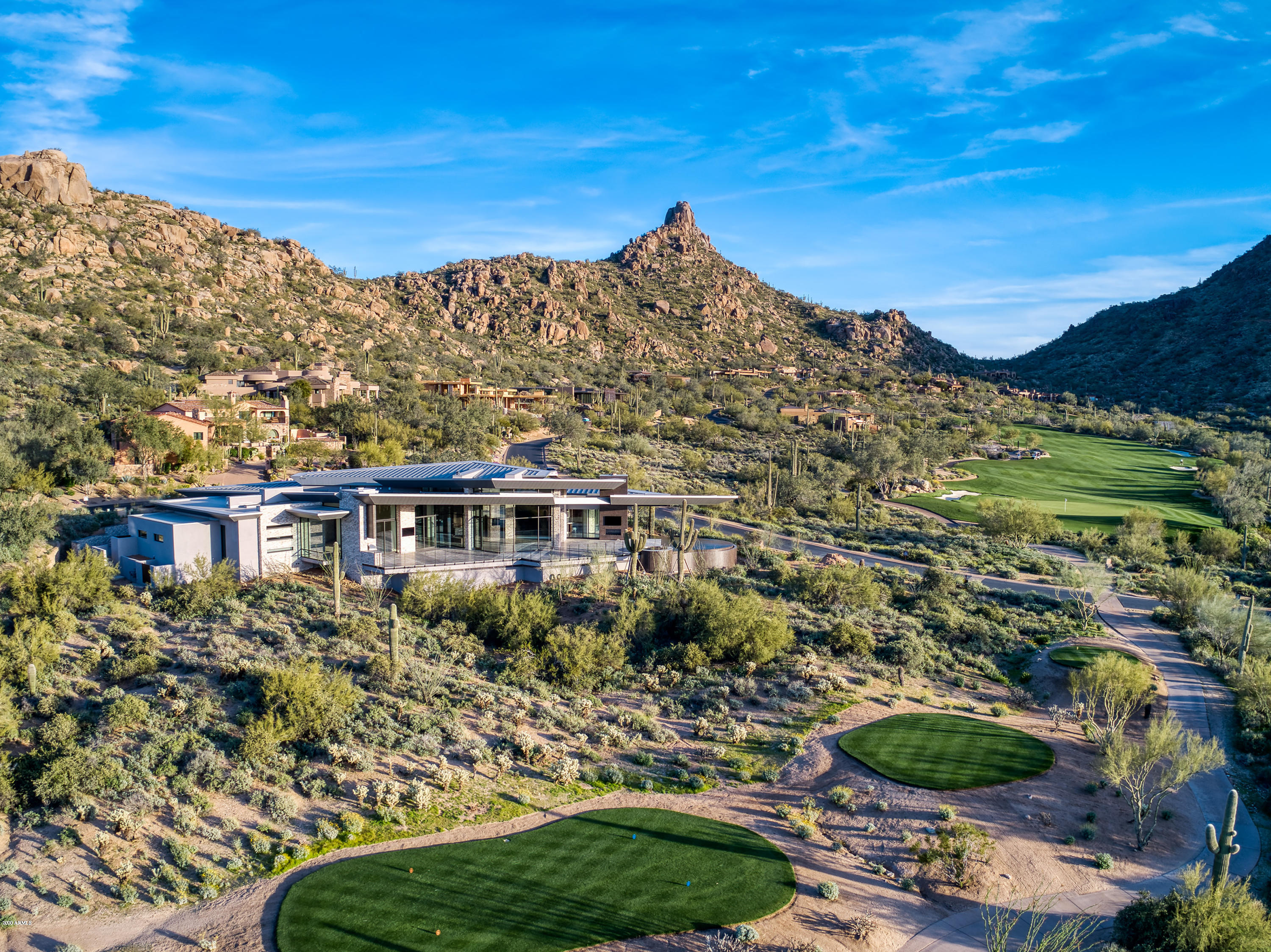 Very Dramatic Architecture with equally dramatic and expansive views. The panoramic views include full city, as well as the 8th and 9th Estancia golf fairways, Pinnacle Peak, & Flat Top Mtn. The large Great Room faces this ''knock your socks off'' view, along with views of the pool and spa that wrap around the patio and house with water up to the windows. Multiple electric glass disappearing sliding glass doors open up to the patio. A central hallway/gallery separates the winged roof areas with skylights running the length of the house. There are no steps in this home. Interior and exterior retractable sun shades, including blackout shades in all bedrooms. Heated radiant floors in Master Bath. Additional Exercise/flex room and climate controlled wine storage in Dining Room.