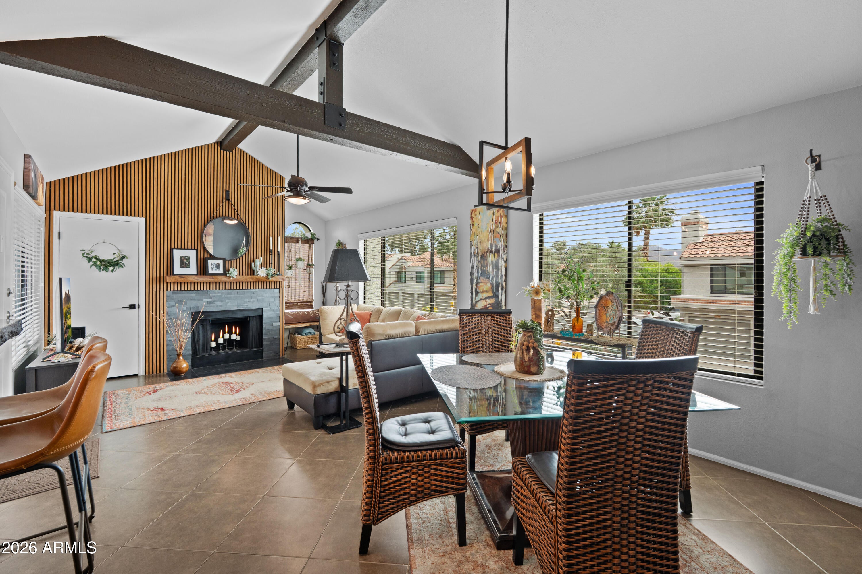 Tucked inside the gated community of Venetian II in the heart of Scottsdale, this beautifully updated condo offers the perfect blend of comfort, style, and location. Just minutes from Scottsdale Ranch, residents enjoy easy access to Scottsdale Ranch Park & Tennis Center, scenic walking and biking paths, nearby lakes, golf, popular restaurants, shopping, and endless entertainment. With quick access to the Loop 101, you are also just a short drive from Kierland, Old Town Scottsdale, and the McDowell Mountain hiking trails. Beautifully maintained and move-in ready, this charming 1 bedroom, 1 bathroom home features a rare 1-car garage, private front patio, and beautiful views of the McDowell Mountains from the interior window, filling the home with natural light. Inside, soaring 11-foot vaulted ceilings with exposed beams create an open and airy feel, while the upgraded fireplace surround with custom acoustic soundproof panels adds warmth and character to the living space.
The kitchen has been thoughtfully updated with granite countertops featuring a chiseled edge, stainless steel appliances, soft-close cabinetry, and a breakfast bar perfect for casual dining or entertaining. Additional highlights include NO carpet, custom closets, wood blinds, tile flooring throughout, newer windows, a newer water heater, and a 2024 HVAC system with transferable warranty for added peace of mind. The spacious bathroom offers a walk-in shower, vessel sink, upgraded fixtures, and a skylight that brings in even more natural light. All appliances convey, making this truly move-in ready. Venetian II residents enjoy a beautifully maintained gated setting with resort-style amenities, all while being surrounded by some of Scottsdale's best outdoor recreation, dining, and lifestyle conveniences.