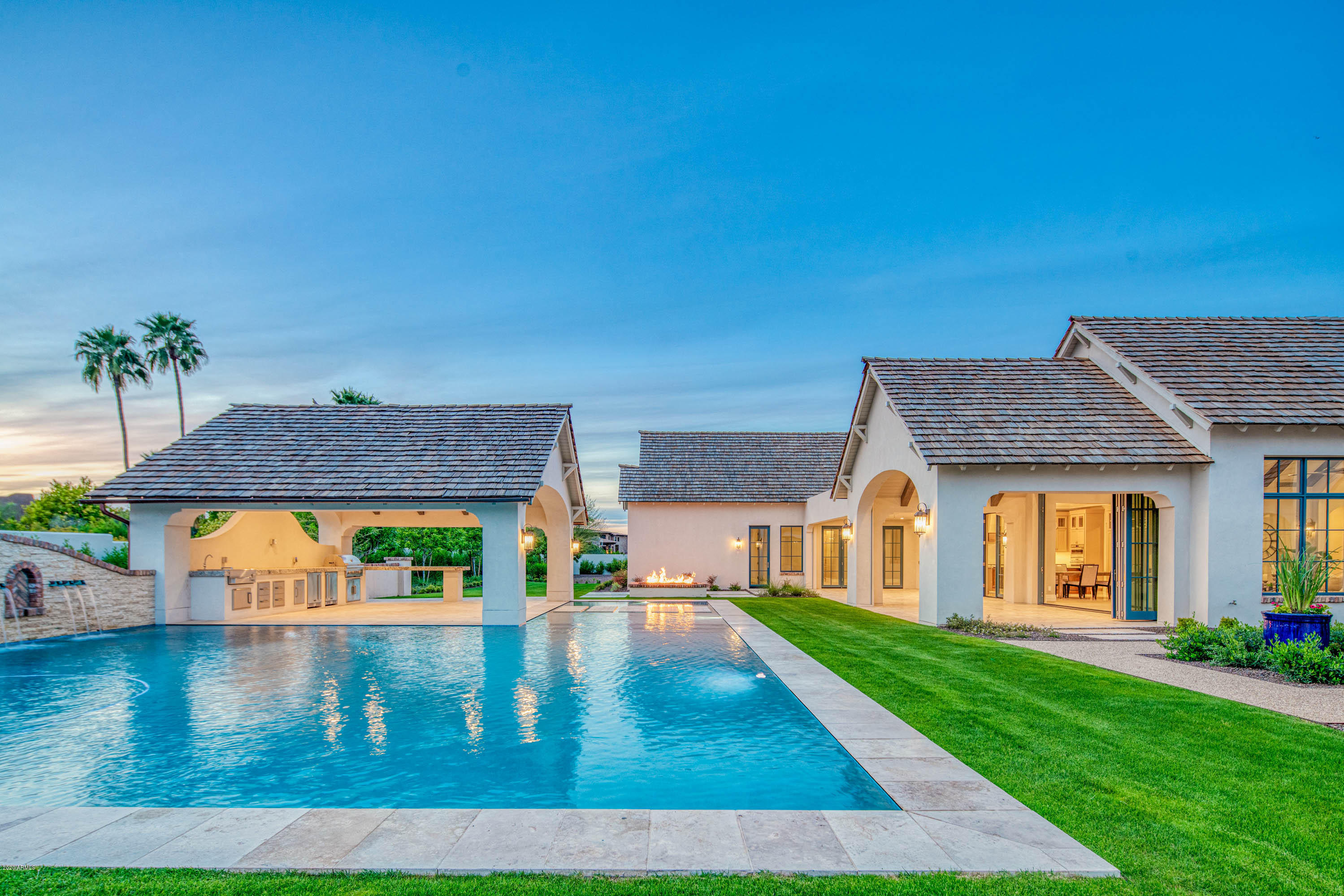 Designed and built with a level of quality, craftsmanship and attention to detail rarely seen, this stunning new country modern residence by West Construction is the home dreams are made of. Tucked away in a quiet, highly desirable location of Paradise Valley with incredible views of Mummy Mountain, you enter the home and sense something special. The rooms are light filled and you're drawn to the custom finishes and meticulous appointments throughout. The layout is ideal, very well thought out and blends indoor/outdoor spaces seamlessly. Highlights include: a gorgeous split master suite with private patio, spacious family room, chef's kitchen with butler's pantry and wine refrigerator, incredible backyard Ramada, negative edge pool with swim up bar, outdoor kitchen. and impeccably designed landscaping. This incredible home makes the most of the amazing desert lifestyle on offer and is truly a home you'll live in and enjoy for life.