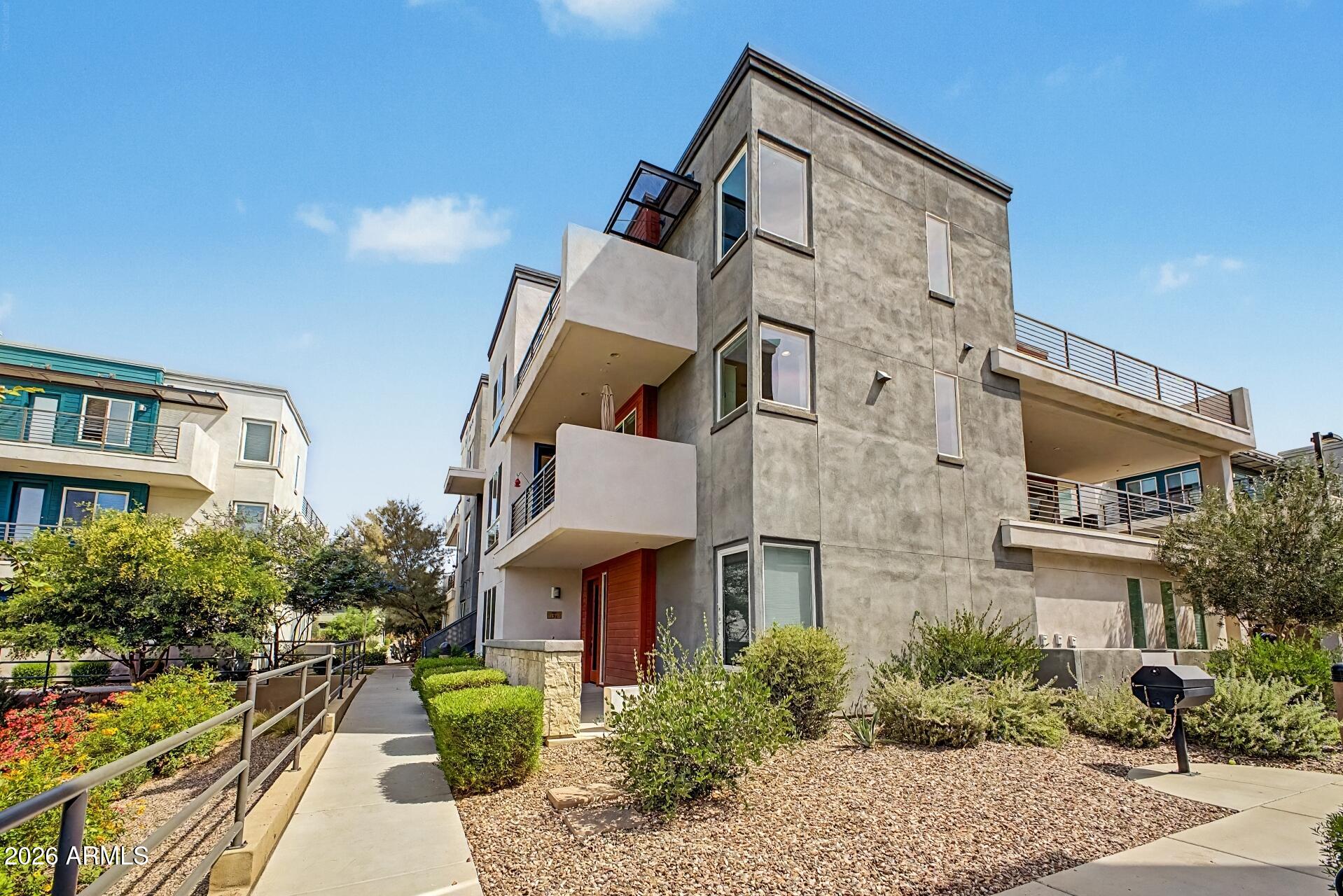Welcome to this exceptional three-bedroom townhome in the popular Rhythm community! Enjoy resort-style amenities, including a gym, pool, Ramadas with bbq's, and cozy fire pits. The modern kitchen features upgraded white cabinetry, quartz countertops, a stylish herringbone backsplash, stainless steel appliances, and an island with a breakfast bar. The main level boasts wood-like porcelain tile flooring, a convenient powder room, and a balcony ideal for alfresco dining. Upstairs, discover three spacious bedrooms and two full baths. The primary suite includes an upgraded walk-in shower and oversized vanity, while the guest bedrooms share a bath with a shower-tub combo. Additional balconies off the primary and middle bedrooms offer sereneGreen Belt views. Don't miss this extraordinary home.