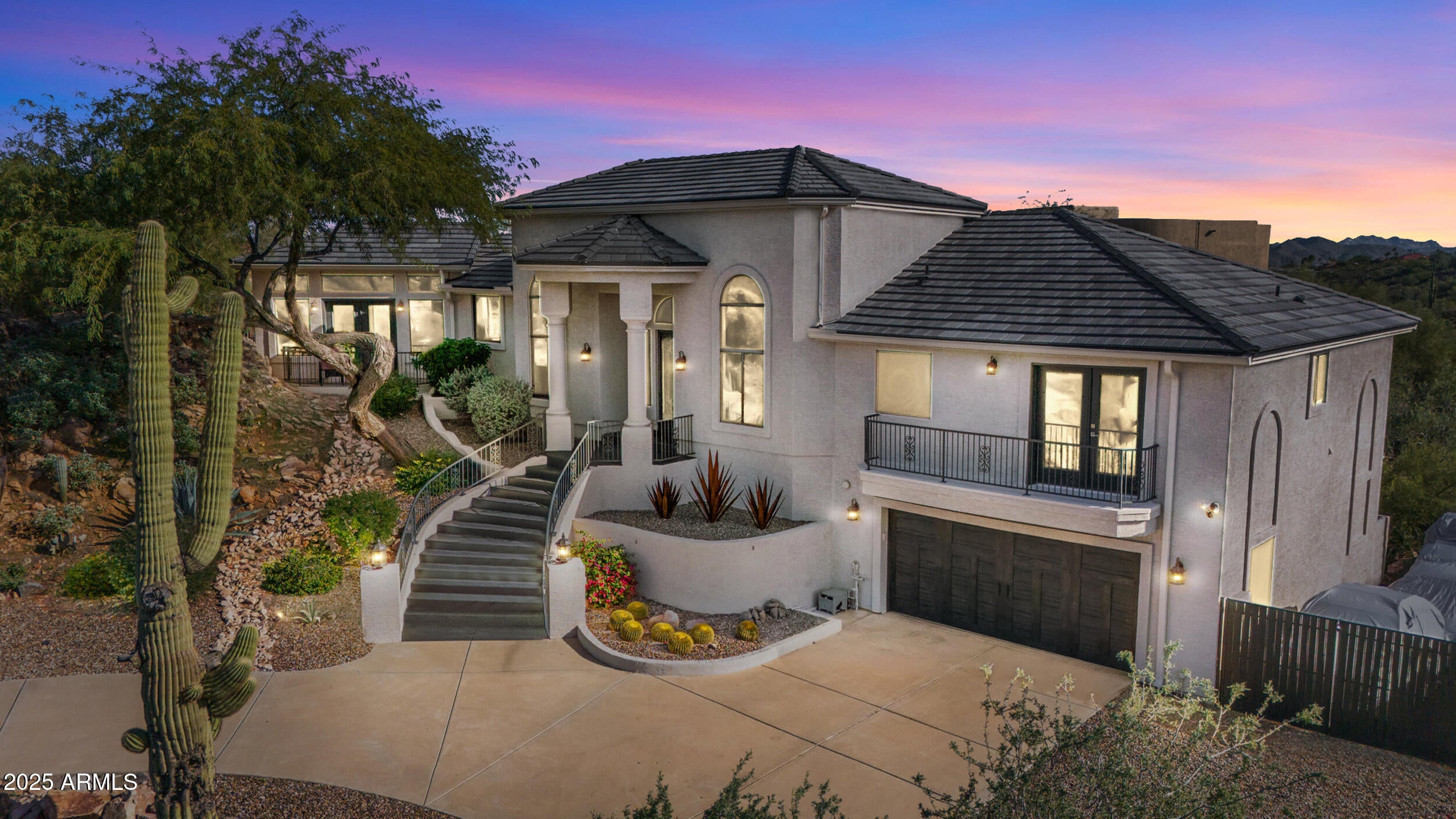 A home that feels like it was discovered, not built. Perched amid massive rock outcroppings, this one-of-a-kind home located on the prestigious street of Sunburst Drive rises naturally with the desert unfolding around it like a private sanctuary. From the moment you arrive, the setting feels cinematic: sun-warmed boulders, endless mountain silhouettes, and the kind of quiet you can feel. Step inside and the views follow you—framed in the plethora of windows are mountain views, open desert, and majestic sunsets. This fully remodeled home boasts soaring ceilings, and plenty of room to share its beauty with family and friends with 4 bedrooms and 2.5 baths along with a formal dining room, living room, eat-in kitchen, huge granite kitchen island with waterfall that seats 6, a family room with fireplace, hardwood flooring throughout (no carpet), and beautiful marble slab shower and marble counters in all the bathrooms. Choose your view from the multiple balconies and patios, watch the sunset over the McDowell Mountains, or gaze at the iconic Red Mountain out your bedroom window. The beautiful finishes are just the start, this home also has a brand new roof including new tiles, fresh paint and much more (check out the updates list in the documents tab). The acre lot gives you endless room to breathe and relax. And with this much space, you can expand the home or choose to build an additional dwelling unit, the possibilities are endless. Enjoy the rare privacy that comes from having nature as your closest neighbor, but still so close to Scottsdale. A retreat, a statement, and a piece of the desert's quiet majesty, all wrapped into one unforgettable Stoneridge property. View it today before this one of a kind home is sold.
