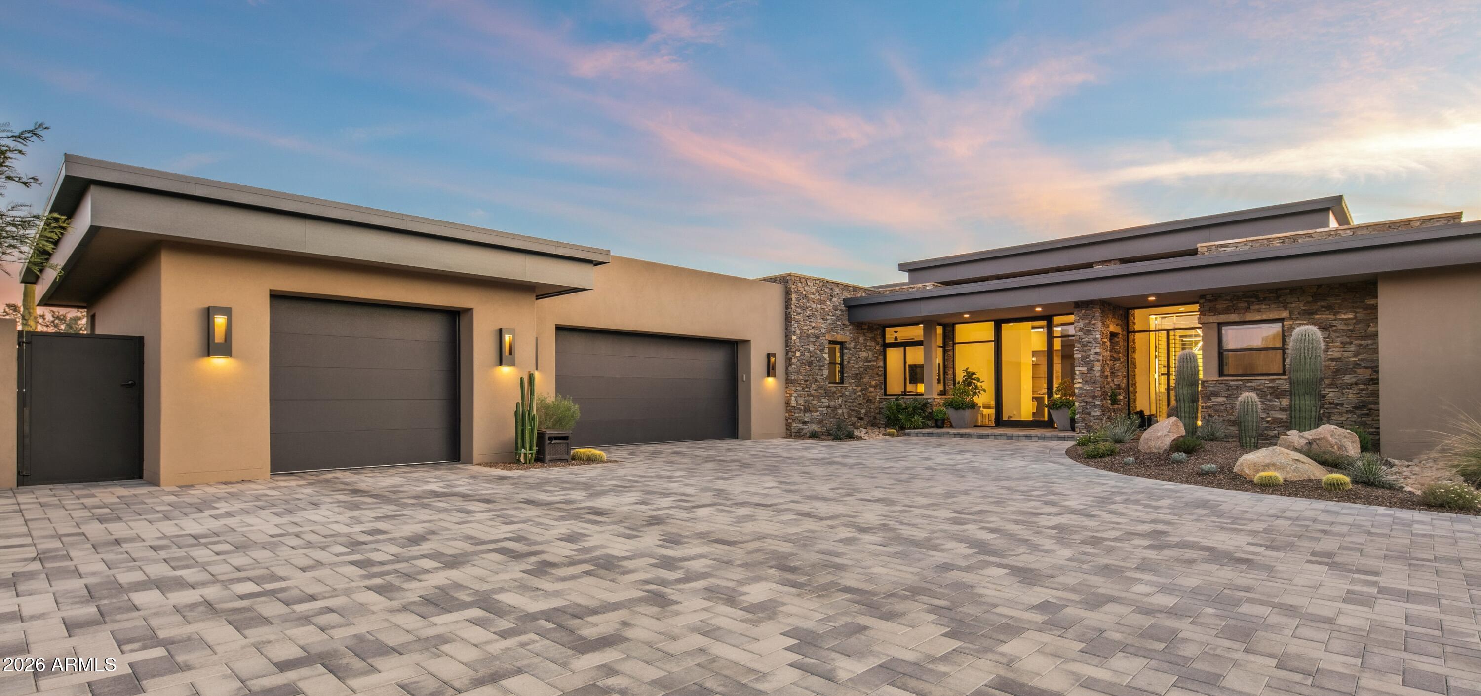 Golf Membership Available- Experience refined desert living in this brand new, elevated, exquisitely crafted residence located in Desert Mountain's prestigious Village of Rose Quartz. From its inception, this home was envisioned and executed without compromise. Designed by renowned architect Scott Lenz and masterfully constructed by Geist Builders, every element reflects intentional design, superior craftsmanship, and enduring quality. Thoughtfully elevated yet seamlessly integrated into the natural desert landscape, the residence offers true single-level living both indoors and out. Upon arrival, a dramatic glass entry door sets the tone—sophisticated, inviting, and instantly calming. Walls of retractable glass dissolve the boundaries between inside and out, unveiling sweeping mountain , desert, and twinkling city-light views that define the essence of Arizona living. The floor plan is impeccably executed with a desirable split design. The private Primary Retreat is peacefully separated from the main living areas, while two luxurious guest ensuites occupy the opposite wing, providing comfort and privacy for all. A 4th bedroom ensuite or office is located on another end of the home for an additional private retreat. The open-concept living spaces are ideal for both entertaining and everyday enjoyment. At the heart of the home is a showstopping Chef's kitchen featuring an expansive island with seating for five, exquisite stone surfaces, top-tier appliances, and a conveniently located walk-in pantry. Adjacent gathering areas encourage connection, while the striking wet barwith its floor-to-ceiling, temperature-controlled glass wine roommakes an unforgettable statement visible from the moment you enter. A sleek, floor-to-ceiling linear fireplace and mounted television create a warm, modern backdrop for relaxed evenings or lively conversation. Outdoor living is nothing short of extraordinary. The  L-shaped pool with Baja entry, spa with cascading water feature, covered patio for lounging, and built-in grill for alfresco dining offer a resort-style experience at home. A putting green adds playful charm, while the fire pit provides the perfect setting to savor Arizona's legendary sunsets as the sky transforms in brilliant hues.Exceptional features include spray foam insulation, an air-conditioned garage, and tankless water heatersjust a glimpse of the many high-performance enhancements throughout. This brand new residence has been impeccably maintained and can be purchased furnished with curated Restoration Hardware pieces, enhancing its turnkey appeal. Ideally situated within Rose Quartz, the home enjoys elevated vistas and convenient access to Desert Mountain's world-class amenities. For those seeking an exceptional lifestyle defined by luxury, comfort, and natural beauty, this remarkable property invites you to embrace the very best of desert living.