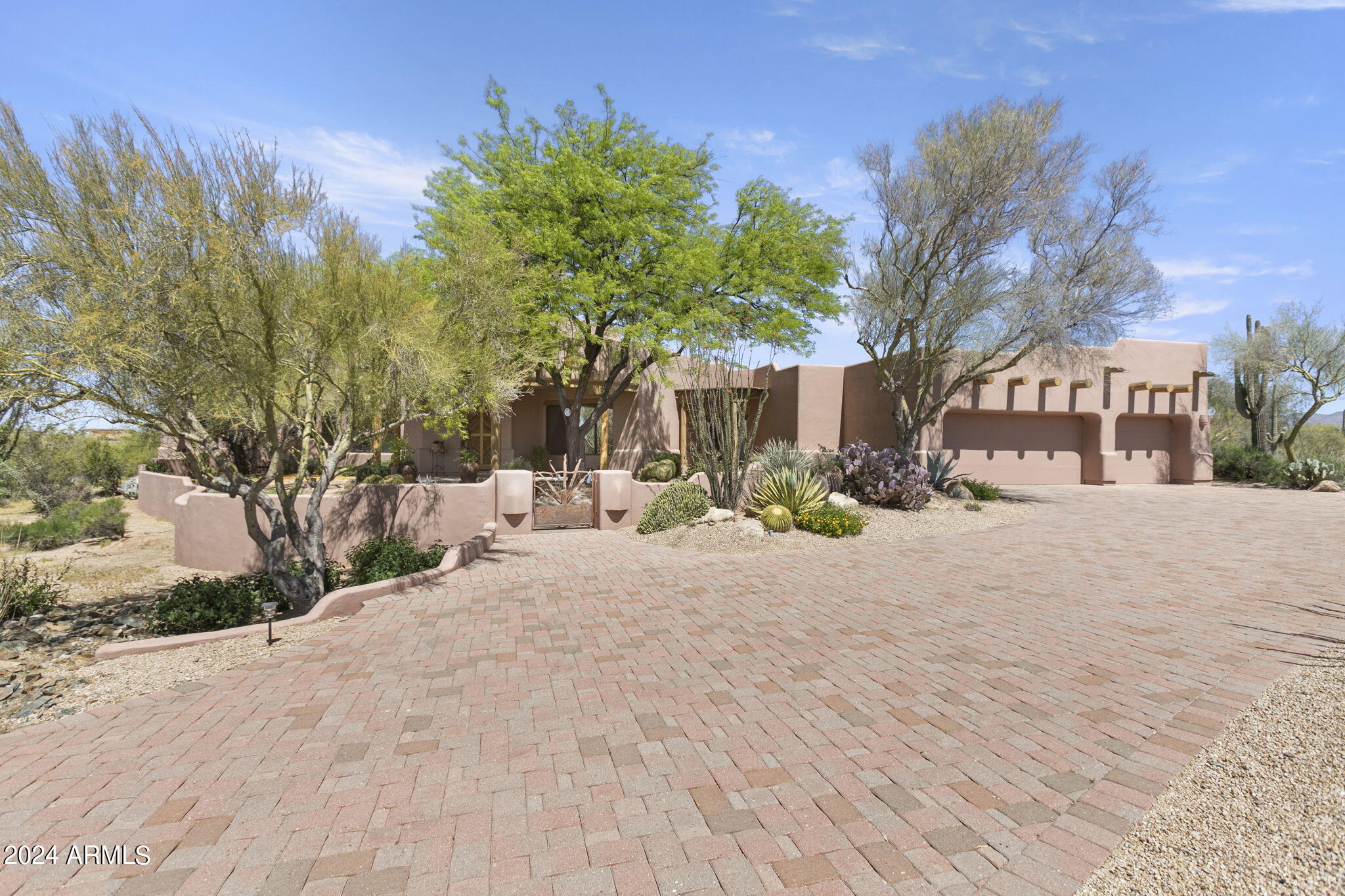 Nestled within the prestigious and serene Sincuidados neighborhood, this residence epitomizes desert living. Tucked away on one of the largest lots within the subdivision, this home offers enviable privacy and breathtaking mountain vistas. Priced as an exceptional opportunity for those who appreciate the timeless allure of classic Southwestern charm, those seeking an opportunity to personalize a residence to suit their own tastes and preferences will also find this enticing. Upon entry, soaring ceilings and expansive windows flood the space with natural light, creating a sense of openness and warmth. The gourmet kitchen is adorned with custom saguaro spine cabinetry, sleek granite countertops, and high-end appliances, perfect for culinary enthusiasts. (MORE) The adjacent living spaces flow seamlessly, offering cozy nooks for intimate conversations and vast areas for festive celebrations. At the end of the hall awaits the master suite, featuring a spacious closet and expansive master bath. From here you will find the private patio where you can relax in the spa and enjoy panoramic views of the surrounding mountains, making it the perfect spot for both relaxation and stargazing. Outside, discover your own slice of paradise amidst the sprawling backyard. Whether basking in the Arizona sun by the sparkling pool or dining on the spacious, covered patio, the outdoor living spaces provide endless opportunities for relaxation and recreation. With its coveted location and expansive lot, this residence offers a rare opportunity to experience the epitome of desert living in the exclusive enclave of Sincuidados.
