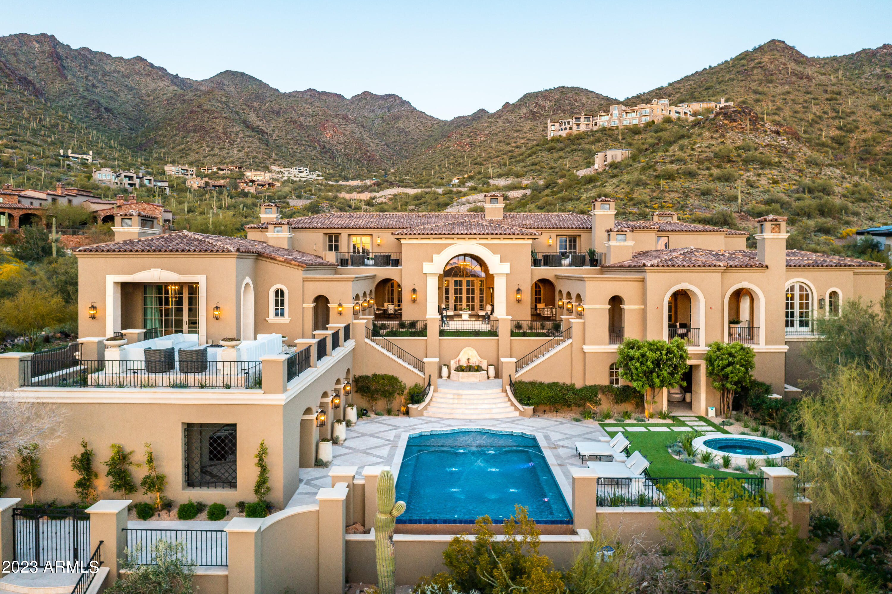 The Formal Mediterranean estate spans across a sprawling landscape, providing a sense of privacy and tranquility for its
discerning owner. The meticulous design by Jamie Rose Interiors is evident in every detail, from the exquisite finishes to the
thoughtfully planned entertainment spaces. The outdoor oasis is a true retreat, with a heated private pool and spa, as well as a bar area that's perfect for hosting guests or enjoying quiet moments of relaxation. The elevated patio, complete with two firepits, offers a vantage point to capture breathtaking views of the majestic mountains, sparkling city lights, and awe-inspiring
sunsets. A Golf Membership to the exclusive Silverleaf Club is available, offering access to world-class amenities and a prestigious lifestyle.