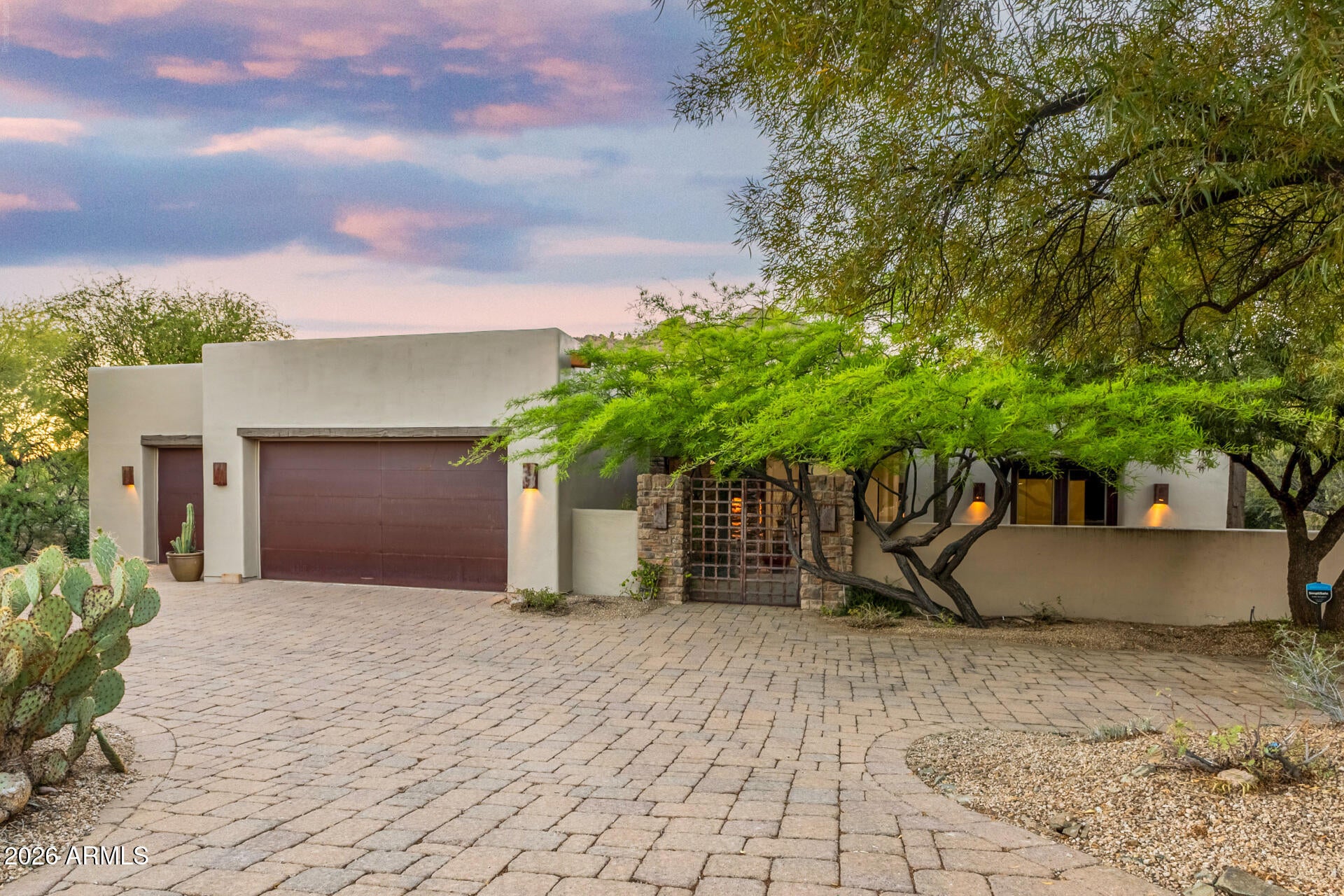 Tucked at the end of a quiet cul de sac in the prestigious guard gated community of The Boulders, this home captures the essence of private desert luxury living. Set on a premium lot with no neighbors behind, the property opens to breathtaking boulder formations and sweeping mountain views that create a truly peaceful and secluded setting.

Inside, soaring ceilings and dramatic floor to ceiling windows flood the home with natural light and perfectly frame the stunning desert landscape from the main living areas and primary suite. The open layout feels both spacious and inviting, designed to take full advantage of indoor outdoor living. The kitchen has been elevated with a brand new never used GE Monogram appliance package, offering a true high end culinary experience with top tier finishes and a large island that anchors the space.

The primary suite is a private retreat with its own fireplace, expansive windows, and direct access to the backyard. Each additional bedroom offers its own patio access through glass doors, along with walk in closets and full bathrooms, providing comfort and privacy for guests or family.

Step outside to a resort style backyard where desert landscaping, natural boulder views, and a sparkling pool come together to create an incredible outdoor experience. Multiple patio spaces offer the perfect setting to relax, entertain, and enjoy Arizona's year round sunshine in total privacy.

This is a rare opportunity to own a home that truly embraces the beauty, serenity, and lifestyle of Carefree living.
