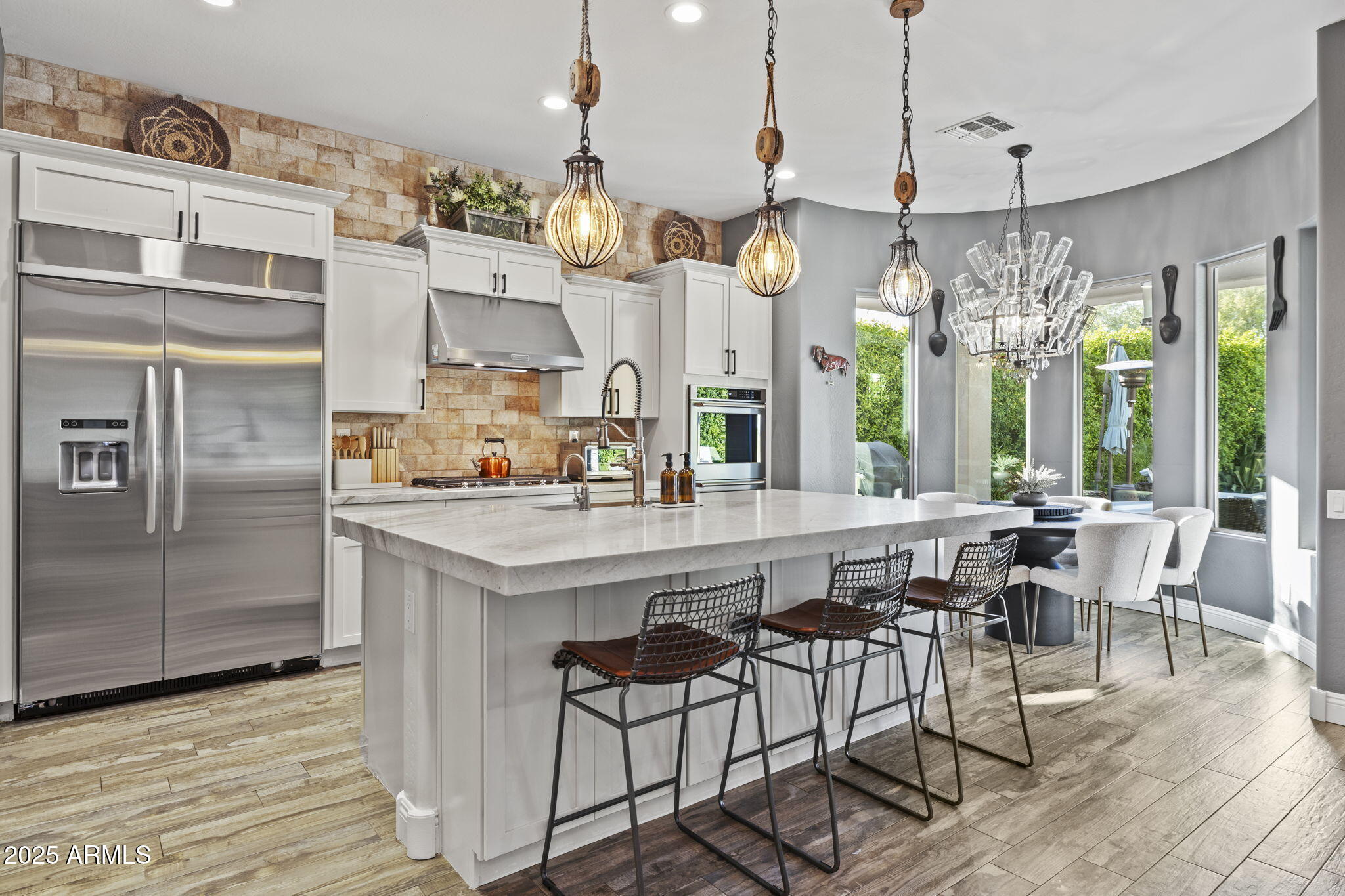 Welcome to 3770 E Ringtail Way! A highly upgraded 3,552 sq ft masterpiece on an oversized lot in the heart of Fireside at Desert Ridge, where luxury meets lifestyle. This 4-bedroom, 3.5-bath home is filled with refined finishes, custom touches, and thoughtful design throughout.Step into your private retreat through a charming paver courtyard with a pergola — the perfect place to sip your morning coffee or enjoy a quiet start to your day. This inviting space sets the tone for the comfort and elegance that continue throughout the home.

Inside, you're greeted by warm wood-look plank tile flooring, elegant wainscoting, and rich wood beams that bring depth and character to every space. Plantation shutters offer a timeless touch, while a striking brick accent wall in the dining room and a brick stair surround create a cozy, curated feel that blends style and comfort beautifully. The kitchen is a standout with Taj Mahal quartzite countertops, custom cabinetry, stainless steel appliances, a five-burner gas cooktop, and an oversized island perfect for entertaining. The open-concept living area features a custom wood feature wall, built-in surround sound, and seamless indoor-outdoor flow for everyday living and special gatherings.

Upstairs, the spacious primary suite offers a quiet escape with a spa-inspired bath and a fully customized California Closet system. A large loft, well-appointed secondary bedrooms, and generous storage complete the upper level. The garage features an epoxy-coated floor and ceiling-mounted storage racks. The oversized lot includes a spacious front courtyard and generous side yard, offering rare flow and flexibility. The backyard is finished with porcelain tile flooring, professional landscaping to include lighting, and a beautiful outdoor fireplace that adds warmth and ambiance. Whether relaxing or entertaining, the outdoor space mirrors the comfort and style found inside.

Fireside at Desert Ridge offers two sparkling resort-style pools, a full fitness center, tennis and basketball courts, and a 16,000 sq ft clubhouse. All just minutes from Desert Ridge Marketplace, top schools, golf, hiking, and Loop 101.