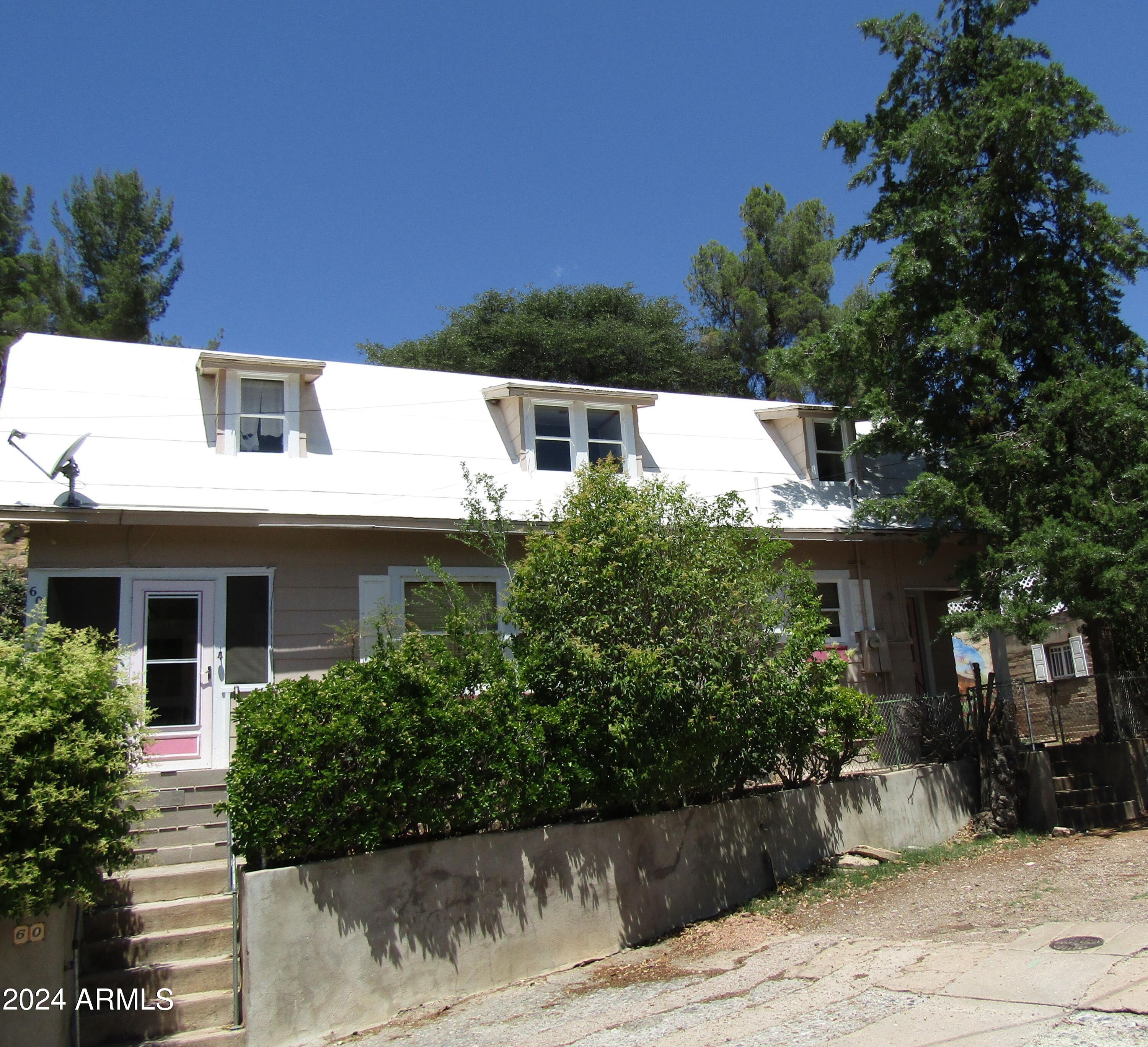 Fabulous location near the end of Wood Canyon above Old Bisbee. Garage and room for more parking. Southern lot is probably buildable. Northern lot has outbuildings great for shop space, art studios motorcycle garage - you name it. Property is 3 LOTS in total. Comfortable 2 story house with nice flat yards at both levels. 2 upstairs bedrooms and 1 downstairs. One bathroom on each level. A good set up for short term rentals. Solid wood floors.