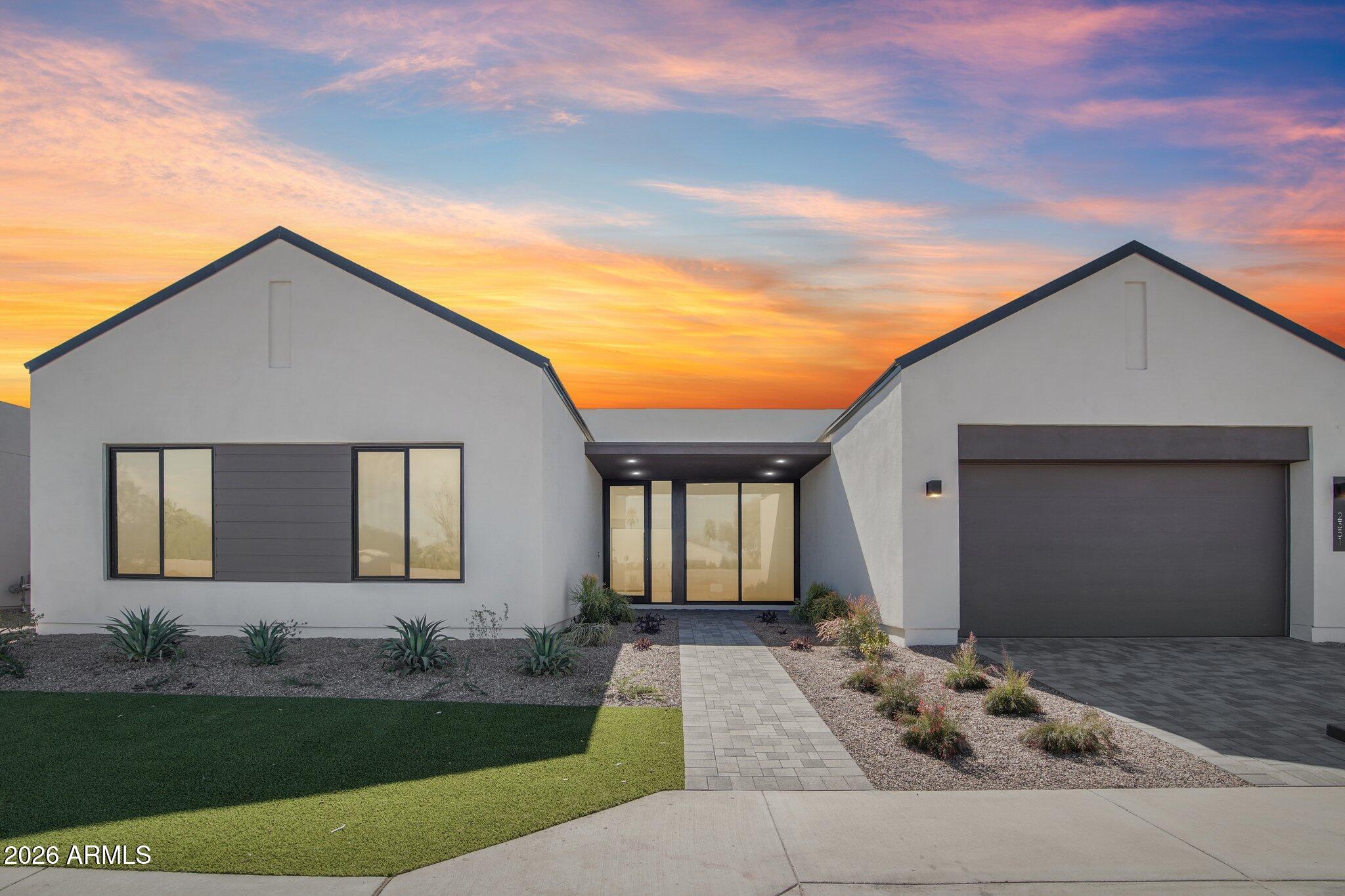 Experience modern luxury and thoughtful design in this beautifully upgraded home offering 4 bedrooms plus a den, 3.5 bathrooms, 3,157 sqft, and a 3-car tandem garage. The open and inviting layout is highlighted by a stunning 72'' fireplace in the great room, creating a warm focal point for gathering and entertaining. Throughout the home, engineered hardwood flooring adds timeless elegance, while upgraded large-format tile enhances the bathrooms. The gourmet kitchen is a true showpiece, featuring a KitchenAid appliance package, pot filler at the cooktop, and an undercounter beverage center. Striking Taj Mahal Satin Quartzite countertops elevate the space, including a dramatic waterfall-edge island and a full Quartzite backsplash that brings both luxury and durability. Matte black fixtures.. provide a modern contrast, while Mirlux Mat Tan cabinetry in the kitchen and primary areas and Aries Taupe cabinetry in the secondary baths add warmth and style. The primary and powder rooms also feature Taj Mahal Satin Quartzite counters, while secondary bathrooms include Quartz countertops. The primary suite offers a spa-inspired bathroom with rain and handheld shower heads, complemented by comfort-height toilets throughout the home for added convenience. A den with a stylish glass interior door creates a perfect home office or flex space. Additional upgrades include black vinyl windows, customized electrical and low-voltage plans, and wall-mounted garage door openers for a clean, streamlined garage setup. With premium finishes, designer materials, and carefully curated upgrades throughout, this home delivers a refined blend of comfort, style, and modern functionality.
