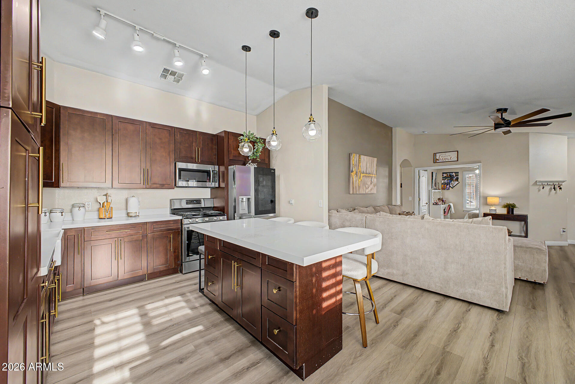 Move-in ready with a true model home feel! Located in Cottonfield Ranch in Laveen, just 5 minutes from the 202 freeway. This beautifully cared for home features 3 bedrooms, 2 bathrooms plus a den that can easily convert to a 4th bedroom. Enjoy an open, flowing floorplan with updated laminate flooring throughout. The remodeled kitchen showcases beautiful wood cabinetry, quartz countertops, gas range, and an oversized breakfast bar with plenty of cabinet and counter space. Bathrooms have been tastefully updated. Spacious primary suite offers a full bath and large walk-in closet. Relax in the grassy backyard with covered patio and above-ground spa--perfect for entertaining.