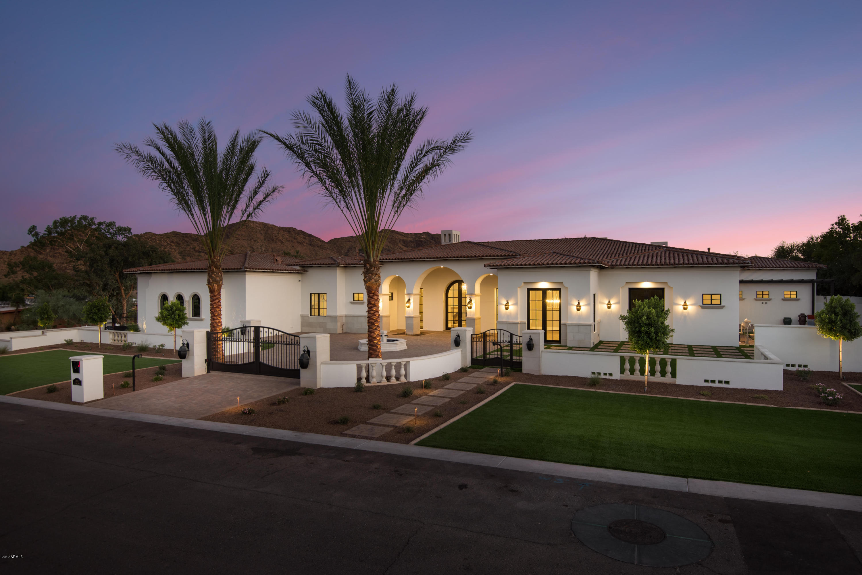 Truly a masterpiece by the phenomenal Regal American Homes--this Santa Barbara style custom home boasts dramatic views of both Mummy Mtn. & Camelback Mtn.! Prepare to be amazed at the quality craftsmanship, open floor plan & over the top finishes-----boasting wood floors, custom cabinetry, soaring high ceilings, & over sized living spaces.  This resort style backyard is truly one of a kind w/ a huge resort style pool/spa/ramada  boasting numerous water features & stunning mountain views---all set in this super private quiet location!
Fabulous master suite w/ telescoping doors & dramatic mtn views in every direction + a beautiful, showy master bathroom suite that features truly jaw dropping mtn views from every inch! Attached guest house provides wonderful privacy for your overnight guests