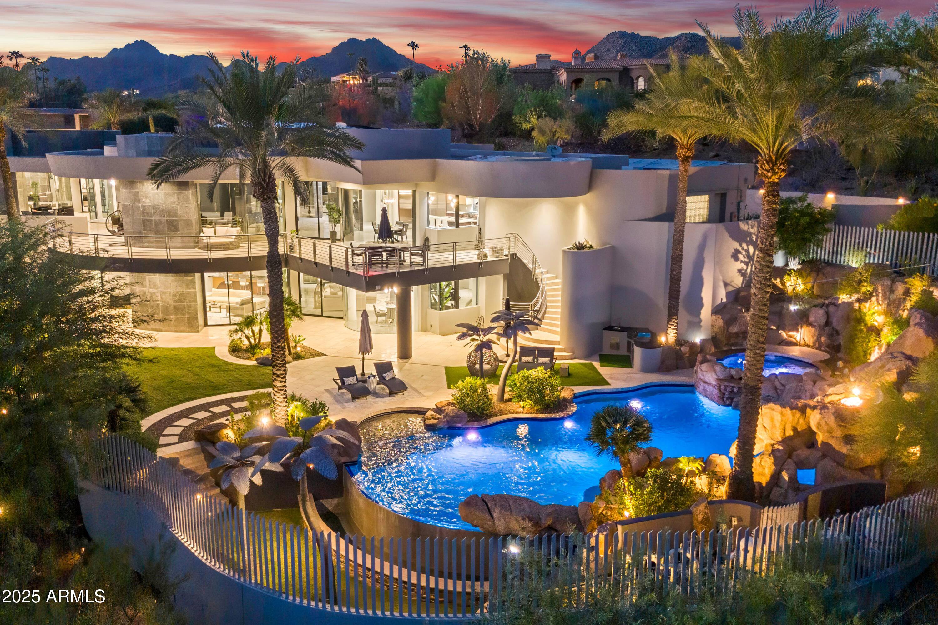 AUCTION - Seller offering property via online auction. Bid online beginning Monday, January 26th with a starting bid of $2.5M. Preview weekend begins Friday, January 23rd. Paradise Views is a gated signature contemporary estate designed by award-winning architect C.P. Drewett & built by Sonora West Development. Located in the heart of Paradise Valley this architectural masterpiece showcases floor-to-ceiling windows framing spectacular Camelback Mountain & city light views. Enjoy the luxury of a private gated entry, chef's kitchen, showcase wine gallery, theater & signature Primary Retreat amidst this premier PV location. Comprehensive updates include extensive solar installation, energy efficiencies & sophisticated finishes. Outdoors, resort-style living provides expansive CLICK ''MORE''. ...expansive curved patios and view decks that capture 180-degree panoramas from downtown Phoenix to Camelback Mountain. The reimagined pool with waterfall, slide, and spa delivers year-round beauty, creating a serene desert oasis ideal for entertaining or relaxing in privacy. Paradise Views offers the rare opportunity to own a signature contemporary home in Paradise Valley, uniting art, architecture, and Arizona's most breathtaking scenery.