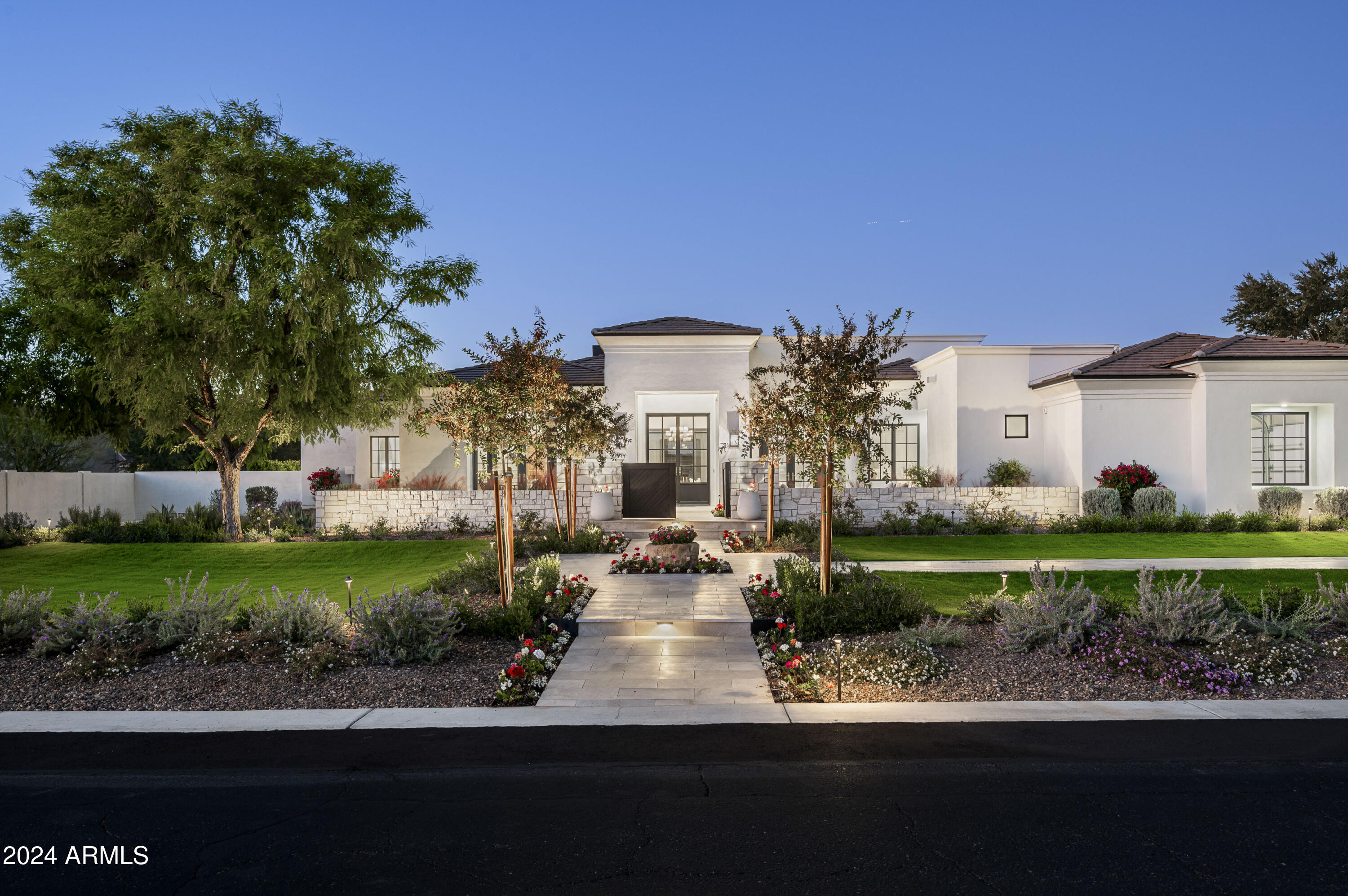 Welcome to MDF Development and Jewel Box Home's latest extraordinary residence in prime Paradise Valley, where luxury and timeless design converge. Situated on a sprawling and flat lot, this single-level, 5 bedroom home with a split floorplan offers high end design coupled with incredible landscape executed by Refine Gardens. The heart of the home is the gourmet kitchen, featuring top-of-the-line Sub Zero appliances and an exquisite European-inspired Ilve oven. With 5 ensuite bedrooms and 5.5 baths, each designed with meticulous attention to detail, this home provides the ultimate in privacy and convenience. The attached casita, complete with a small kitchenette, offers a private retreat for guests or could serve as a perfect in-law suite. As you explore further you'll discover a captivating family/game room with a bar and walk in wine room creating an ideal setting for entertaining. The possibilities are boundless with a vast lot that accommodates your vision for a pool house, tennis court, pickleball courts, or even a show garage. Whether you're dreaming of hosting grand events or seeking a tranquil escape, this residence invites you to turn your vision into reality. In the heart of Paradise Valley, this home seamlessly combines elegance and opportunity, creating a haven where luxury living meets your unique aspirations. Don't wait to see the endless potential and unmatched beauty of this remarkable property.