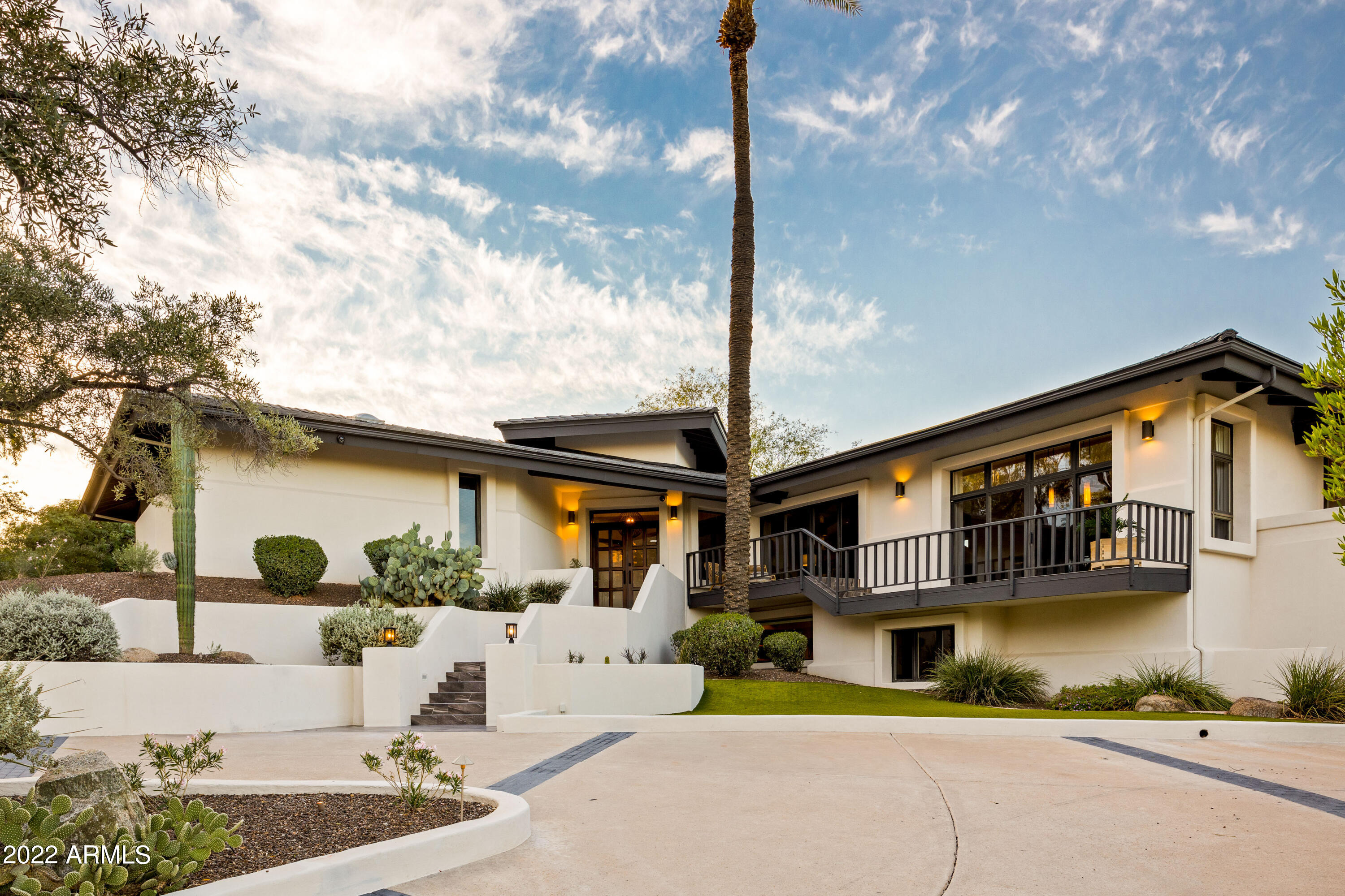 Breathtaking views of Camelback, Mummy, and Phoenix Mountain preserve, as well as  Piestwa Peak from nearly every room.  Feel above it all, with views and privacy, on almost a one-acre lot backing to a wash and sitting adjacent to a vacant lot owned by the community. This hillside residence features 3 bedrooms and 4.5 bathrooms spread over 5300 square feet. Striking a perfect balance between cozy and spacious, this home includes two offices, game room, wet bar, wine storage, and multiple entertaining areas.

The modern and timeless kitchen is equipped with sub-zero refrigerator, two sub-zero crisper drawers, show stopping stainless and copper 6 burner stove with copper hood, and black leathered granite countertops. Open-plan living with an eye for entertaining has a wet bar with gorgeous leathered marble surfaces and two refrigerated wine cellars with a capacity of almost 400 bottles.

 

Main floor living at its best, your spacious primary bedroom with gas fireplace, office/sitting area and two primary closets. You may never want to leave with 3 private patios/courtyards including secluded staircase down to the pool. Downstairs you'll find your two guest bedrooms with spacious on-suites, a game room with sliding glass doors that fill with the beautiful mountain views, a large office, and pool bathroom with exterior door.

 

As if the interior and balconies weren't enough, a brand new entertainers backyard awaits. Completely re-imagined in 2022, the backyard boasts a brand-new firepit, artificial turf, putting green, and travertine pavers. The pool has new pebble tec and a gorgeous waterfall, surrounded by native landscaping and plants. New in 2021; cement tile roof and all new stucco with paint.



Have the feeling of a private hillside location but with the proximity of city living. Minutes to some of the best restaurants and resorts in Scottsdale, Phoenix, and Paradise Valley. Walk to Echo Canyon Trailhead or the new Global Ambassador Hotel. Fifteen minutes to Sky Harbor International Airport.