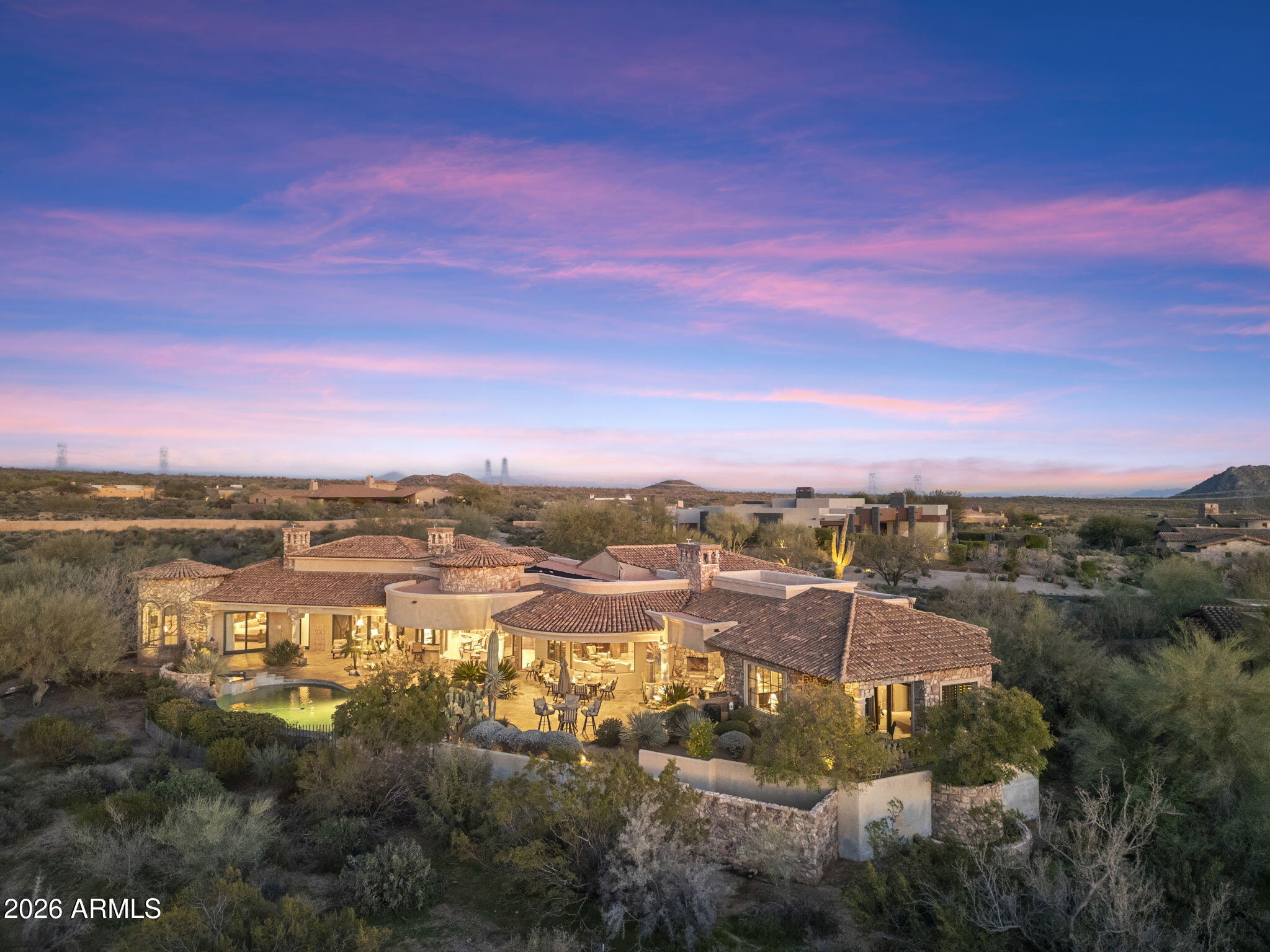 Discover the pinnacle of luxury living in the prestigious Mirabel Club.
Nestled on a serene cul-de-sac overlooking the seventh fairway, this exquisite 2006 Tuscan-inspired residence offers unparalleled golf course and mountain views from nearly every vantage point. Spanning nearly 6,200 square feet of meticulously crafted living space, this single-level home features a secluded Primary Suite and ample guest rooms, including a casita with its own private patio; perfect for visitors or a quiet retreat. Step inside to timeless elegance defined by stone and wood finishes that create a warm, sophisticated ambiance throughout. The impeccably designed floor plan, completely free of interior steps, ensures effortless flow and accessibility. The heart of the home is a gourmet chef's kitchen equipped with ultra-high-end appliances, custom cabinetry, and abundant workspace--ideal for culinary enthusiasts and easy entertaining.
Enjoy a first-class entertainment experience in the theatre, gather at the stylish wet bar, or cozy up by one of the four fireplaces that grace the living areas. Outdoor living reaches new heights with a resort-style infinity-edge pool featuring a babbling spillover spa, an outdoor kitchen for al fresco dining, and expansive patios that frame panoramic views of the fairway, desert and mountains beyond.
This residence combines privacy, prestige, and resort-like living in one of North Scottsdale's most exclusive enclaves.