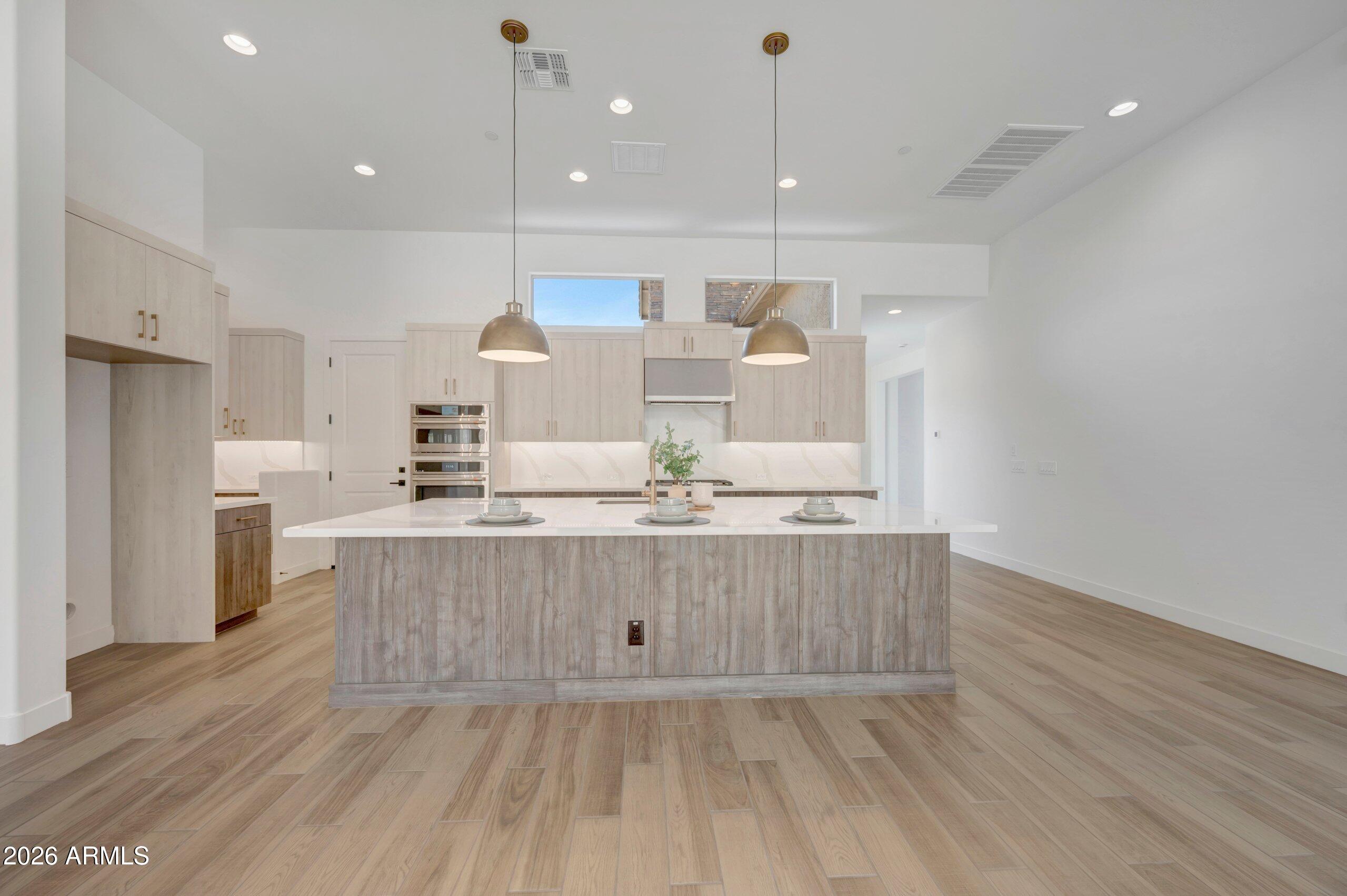 BRAND NEW single level plan with 3 beds, 2.5 baths, a study, an interior courtyard, extended outdoor living area and 3 car garage; incredible 10-12'' ceilings, 8' doors, 12' sliding glass door at entry and 15' sliding glass door to private backyard with gorgeous views of the mountains and city - no backyard neighbors; chef's kitchen with warm, modern cabinets, tons of storage, huge island w/accent lighting, quartz tops with full quartz backsplash, stainless GE Cafe appliances including gas cooktop; plank tile, upgraded carpet/pad throughout; spa-like owner's bath with quartz tops, 2 sinks & huge floor to ceiling tiled super shower with additional rain can showerhead; 2x6 CONSTRUCTION & EXTENSIVE NEW HOME WARRANTY.