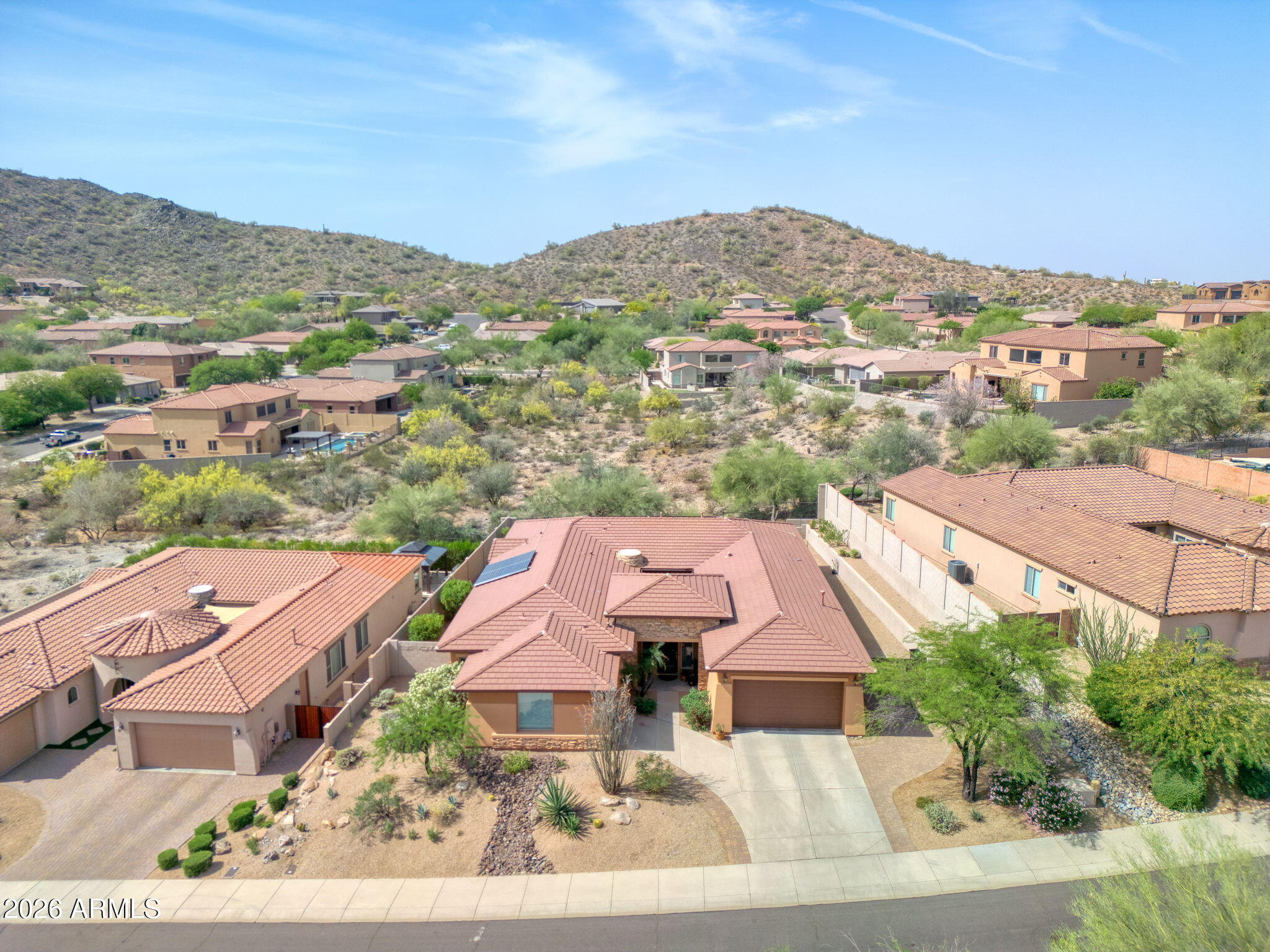 Nestled on a quiet cul-de-sac in a highly desirable, secluded mountain preserve community in North Peoria, this spectacular Pulte home sits on a prime hillside lot that borders the preserve - with breathtaking views through open-view fencing. With 4 bedrooms plus an office, 3 full baths, and 3,209 sq. ft. of thoughtfully designed living space, this home is as functional as it is beautiful.

At the heart of the home lies a stunning private atrium -- a tranquil sitting area with a gas fireplace that fills the home with natural light and a sense of calm unlike anything you'll find in a standard floor plan. Step inside and be wowed by travertine floors and warm tones throughout main area The chef-inspired eat-in kitchen features granite countertops, a gas cooktop with hood, dual ovens, walk-in pantry and a large center island with a breakfast bar.  

Retreat to the luxurious primary suite, complete with a view window, jetted soaking tub, snail shower, dual sinks, large walk-in closet and direct yard access. 

The home is loaded with smart upgrades including a fully owned, grid connected TESLA SOLAR SYSTEM -- installed in 2018 and backed by a 20-year transferable warranty with performance and production guarantees, you are also grandfathered into great solar buy back rates until 2038 -- USA made, efficient TRANE A/C units were installed 2023 (10 year warranty), smart thermostats, sunscreens, R/O, and a new smart garage door opener-  all delivering comfort and incredible utility savings (Avg utility bill has been $20!)

The 3-car garage offers generous overhead storage space, and the RV gate adds flexibility. A whole-home fire sprinkler system and a post-tension slab/foundation add peace of mind.  Entire landscape watering system was recently upgraded.  Recent premium exterior paint adds standout curb appeal & protection.  

A 6 ft Cantera Stone water fountain adds an elegant, resort-like touch to the outdoor living space.  The gentle sound of trickling water creates a peaceful backdrop for relaxation and entertaining, and is beautifully complimented by tumbled pavers throughout, while low-maintenance artificial turf keeps the yard lush year-round.

When adventure calls, you are literally surrounded by parks with many miles of city maintained hiking/biking trails, just minutes from Lake Pleasant, Paloma Lake Park, and around the corner from playgrounds, ramadas, sprawling grass fields, volleyball & tennis courts - as well as a A+ rated elementary school.  

As the lowest priced single level, 3CG of this size in all of Westwing, Cibola Vista & Rock Springs (at time of notation), this home is priced to sell!