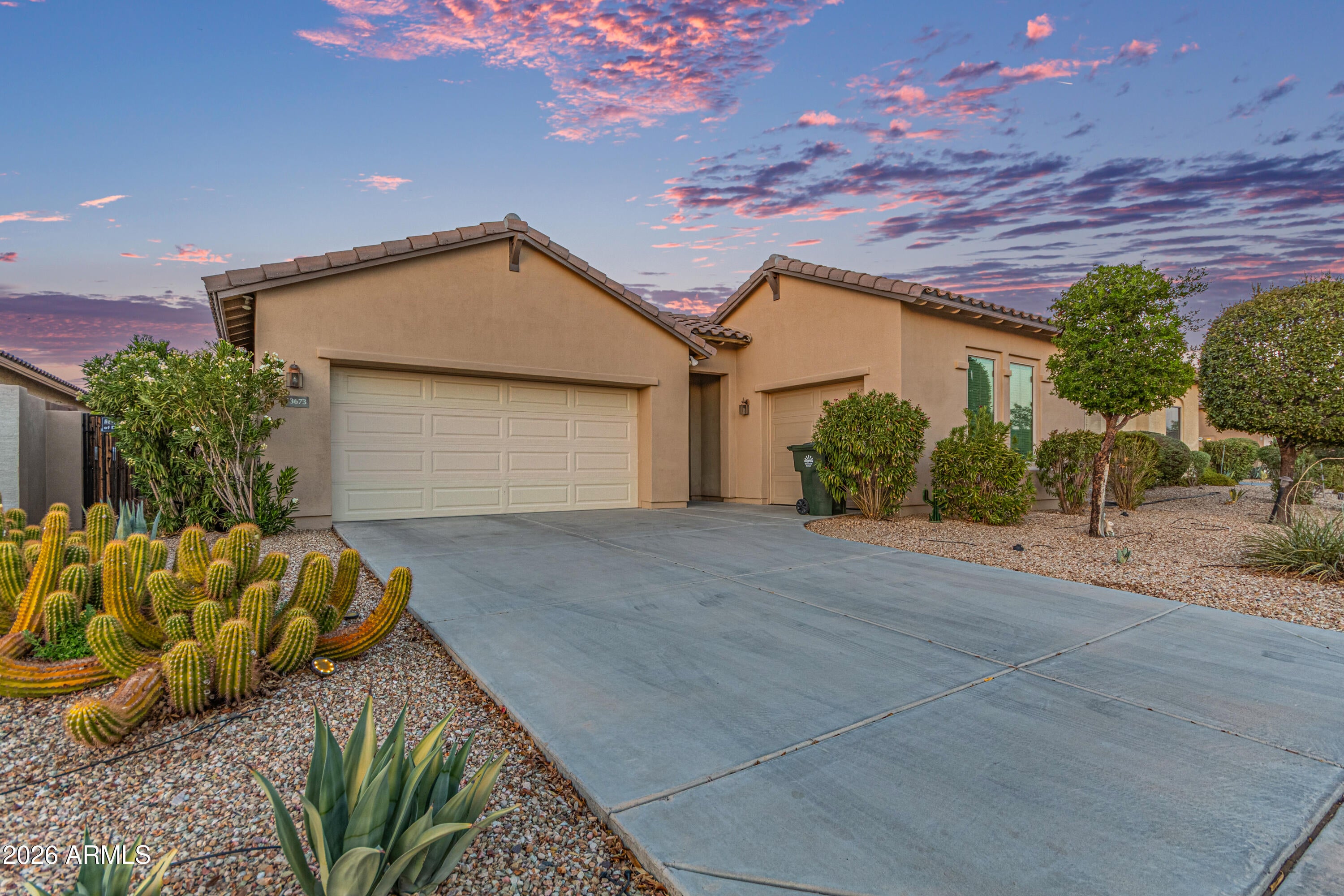 Located in Estrella Mountain Ranch, this well maintained single level home offers 3 bedrooms, 2 bathrooms, and 1,844 square feet with a desirable 3 car garage. Spacious lot with extended driveway provides added parking and flexibility. Open and functional floor plan with tile flooring throughout. Bright kitchen features ample cabinetry, granite counters, center island, main dining area, and a separate breakfast nook. Kitchen flows seamlessly into the main living space, creating an ideal setup for everyday living and entertaining. Split bedroom layout offers added privacy. Primary suite includes dual sinks, soaking tub, separate shower, and walk in closet. Covered patio and low maintenance desert landscaping complete the backyard. Enjoy Estrella's lakes, parks, golf, and amenities! Located in the foothills of the Sierra Estrella Mountains, Estrella Mountain Ranch offers a resort style desert living experience. Residents enjoy two residents clubs featuring fitness centers, heated pools, and water parks. The community includes 72 acres of lakes ideal for kayaking, paddleboarding, and catch and release fishing. Miles of hiking and biking trails wind through scenic desert and mountain terrain. Sports courts, playgrounds, and neighborhood parks are located throughout the community, along with the championship 18 hole Golf Club of Estrella. Regular community events, farmers markets, and resident clubs create a vibrant and active lifestyle, all just minutes from shopping and dining.