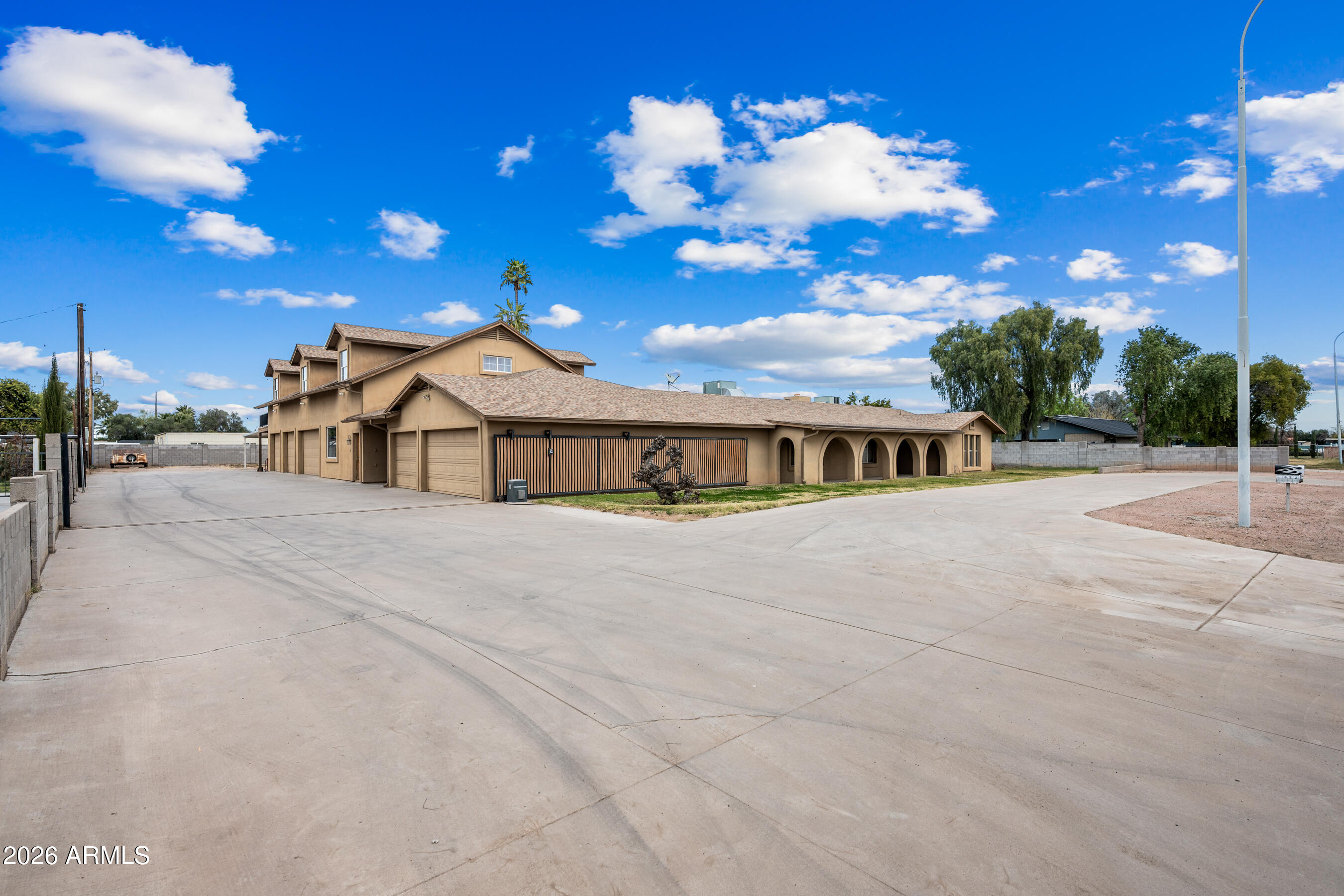 Rare opportunity to enjoy privacy, space, and a quiet neighborhood. Nearly 1 acre, fully fenced and flood irrigation, NO HOA horse property zoned for agricultural use. This versatile, multi-generational estate offers extensive parking, guest quarters, extra large pool, a 3-car garage, and an large climate-controlled shop/garage. Convenient access to shopping, dining, entertainment, and the US60 and 101 freeways.Main home features 5 bedrooms, 2 full baths, and 1 half bath, with formal living and dining, plus a great room with a wood-burning brick fireplace. Spacious kitchen includes gas and electric ovens, granite countertops, large island/breakfast bar, walk-in pantry, and oversized bonus room-perfect for flexible living. Additional highlights include a 3-car garage, extra large fenced pool, above-ground heated spa, and an extra-large circular driveway. Guest suite with private entrance includes a full bath, stackable washer/dryer, and pool-access bathroom door. Upstairs living space offers a full bath, galley kitchen, ample storage, and a large wrap around deck overlooking the lawn and pool.
The 1,642 sq ft shop includes heat/AC, half bath, and 400 AMP service--ideal for car enthusiasts, toys or hobbyists. Property also features extensive covered parking, a appx. 30' electric remote gate with ample concrete parking for RVs, boats, or toys, plus a 40' Conex storage container.
 Located near the end of Tremaine Park neighborhood with no thru traffic, offering a peaceful, country-style setting with easy access to downtown Chandler and downtown Gilbert.
Lift in garage, Air Compressor, Current security cameras do not convey. Hot Tub is in working condition but sold AS-IS No Warranties.
All measurements are deemed to be approximate. Buyer to confirm all measurements and any other details important to them.