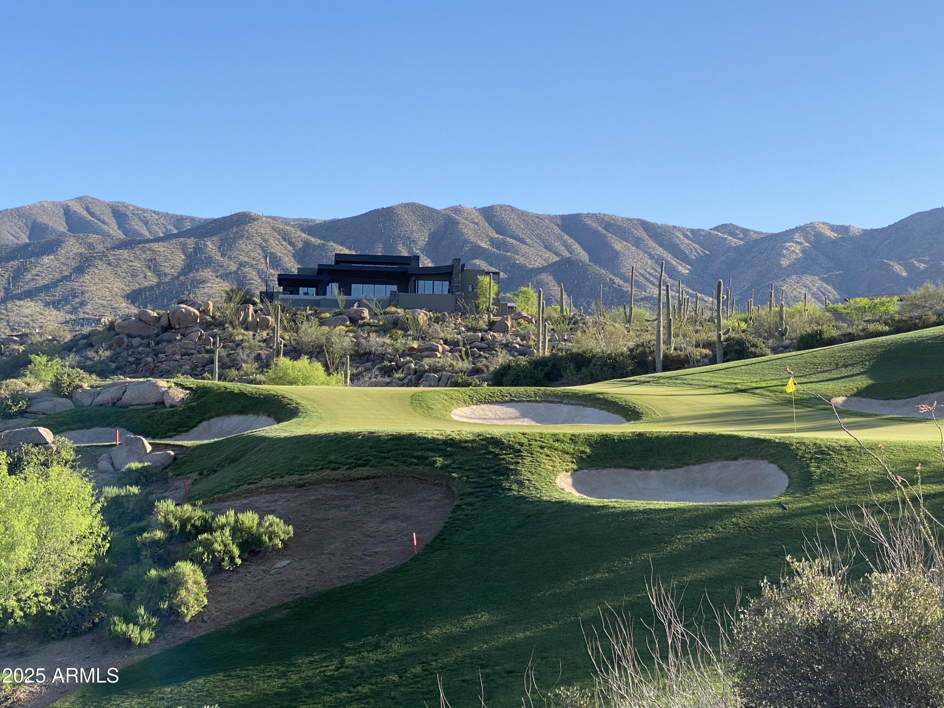 Desert Mountain Golf Membersip available with this exquisit living experience in the custom-built home located within the Saguaro Forest Village in the coveted Desert Mountain community.  Welcome to a seamless blend of soft modern design and comfort.  Meticulously maintained, the flowing living areas have an abundance of natural light from generous walls of windows that meet soaring ceilings.  A gourmet kitchen, stunning wine storage and uncompromised finishes create a luxurious ambiance throughout the 4 bedrooms and 3 ½ baths (no steps) in the home and casita.  Restore and relax in the master spa-like bath with generously sized his and hers closet areas and the convenience of a second laundry room. Embrace the private tranquility of an expansive outdoor living area with unique and sweeping views of city lights and layered mountains nestled behind iconic golf holes.  Create lasting memories entertaining friends and loved ones with an infinity walk-in pool, oversized hot tub, firepits, outdoor kitchen and multiple seating areas.