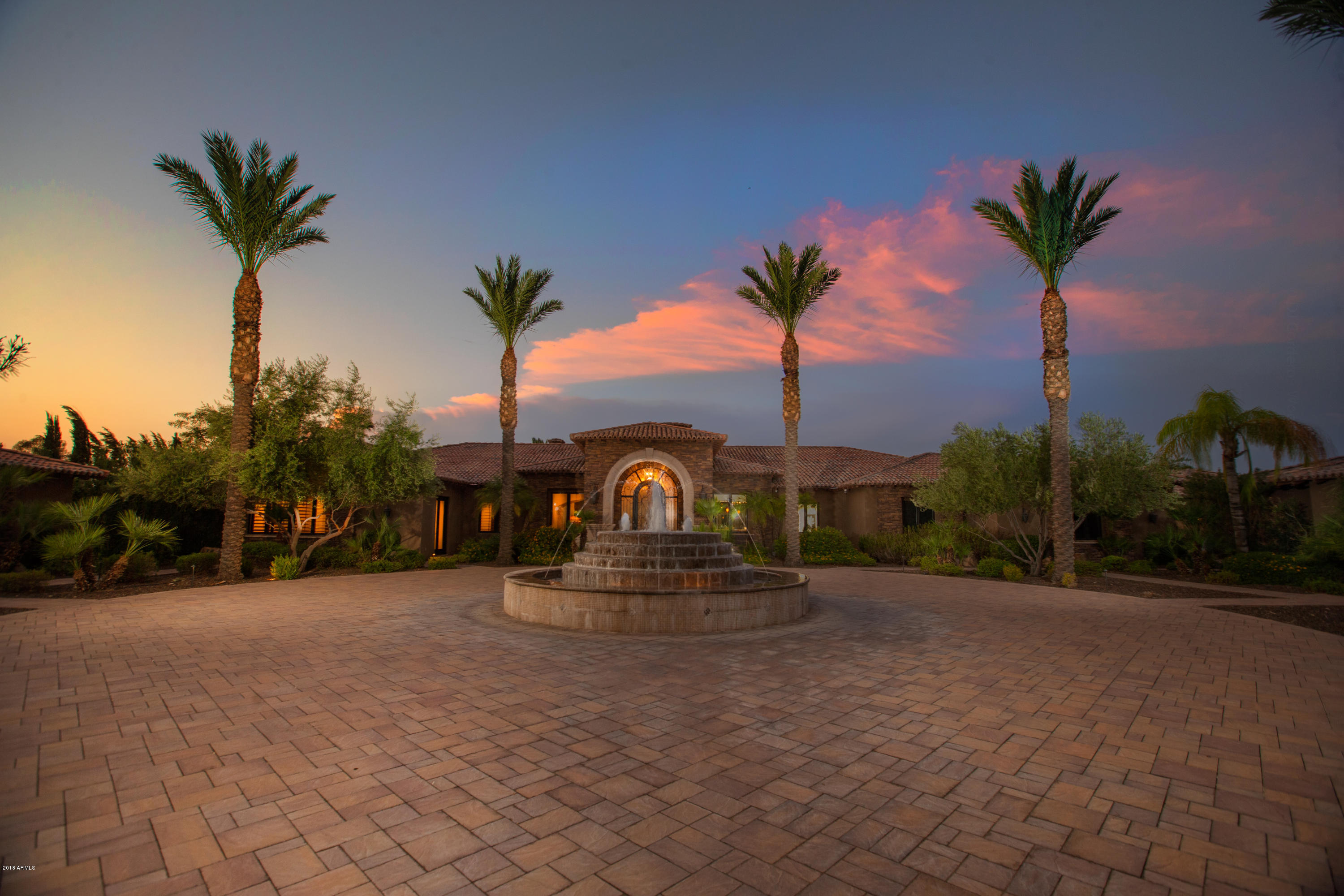 Double gated compound on just under 2 acres, 5 bedrooms in main house with 2 bedrooms in guesthouse for a total of 7 bedrooms.  Guest house with full kitchen, 7+ person theater, billiard area off family room, full bar, bonus room in guest-wing, 1200 bottle wine room, master bedroom with private office, 12+ car garages with additional gated storage, two pools, spa, slide and waterfalls connected by lazy river, batting cage, sport court, putting green, various private gardens, huge outdoor Ramada with kitchen and fireplace. Rarely in Paradise Valley do you find a property that is convenient to the amenities of Scottsdale   and then be so inconspicuous.This elegant and privately gated compound positioned on sprawling grounds affords uncompromised peacefulness of privacy and the luxury of space. From the first moment of entry, the views through abundant windows to the inspiring backyard grounds are just the start of what makes this property special.

The home provides the perfect balance of warmth, intimacy and convenience. A central living area that includes a  family room which becomes an outside extension with it's disappearing slider, large gourmet kitchen, built in breakfast nook, 1200 bottle wine tasting room, spacious wet bar and a pool table area with direct access to the 7 plus person theater.  The 12 car garages, arranged around a large parking court, accessed by a gate of it's own. Additionally there is  a gated boat/toy yard,  plus another gated long drive for any other parking.

The noteworthy features are the backyard views and access from all the major living areas including the the private master bedroom with fireplace.  Included is a large master bath with a hairdressing studio and sauna.  The vast master closet and built out with fine cabinetry.  Off of the master bathroom is a privately walled, generous in size outdoor shower area with a privacy door out to a zen-like garden featuring waterfalls and fire... surrounded by lush green landscape.  

Recently remodeled, this impressive property has been designed with fine living and gracious entertaining in mind.  Comprising of seven total bedrooms and two flex rooms.  Three sumptuous en suite bedrooms in the main house guest wing and two more in the fully appointed guest house. 

The grounds are playful with highlights including a lazy river with various pools with a total of 2500 sf , swim up bar off an outside entertainment covered grotto, built in and submerged lounge beds, waterfalls and a natural slide.  Nestled in the lush greenery are a sport court, putting green and batting cage located across a spacious lawn.  

Total square footage of the main home is 8,125 and the guest home is 1,136 equaling 9,321.