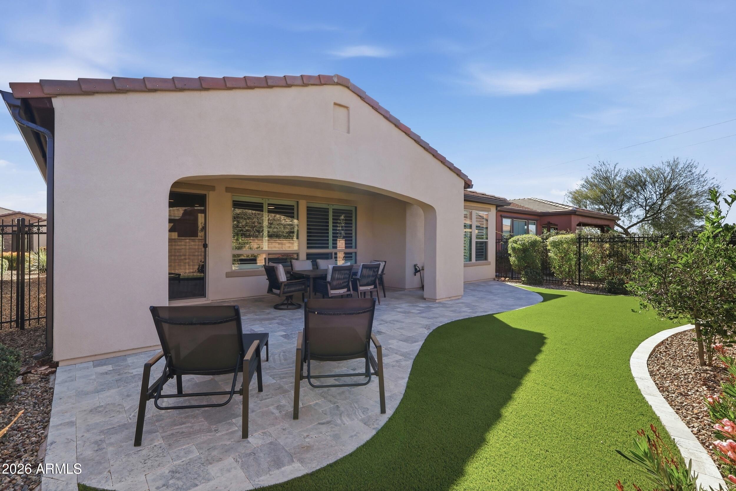 Located in the gated resort community of Encanterra®, this St. Tropez floor plan offers low-maintenance, lock-and-leave living.This 2 bed, 2 bath home features a bright, open layout with plantation shutters and split floor plan.Built in 2020, it offers a newer feel with modern finishes.The kitchen includes granite countertops, staggered white cabinetry, dual ovens, pantry, and built-in desk, opening to the main living area.Enjoy indoor-outdoor living with a covered patio, turf yard, and pavered seating area with mature landscaping.The primary suite offers a walk-in shower and ample storage.The 2-car garage includes space for a water softener, RO system, and water heater.Residents enjoy golf, pools, spa, fitness, dining, tennis, pickleball, bocce, clubs, and activities.