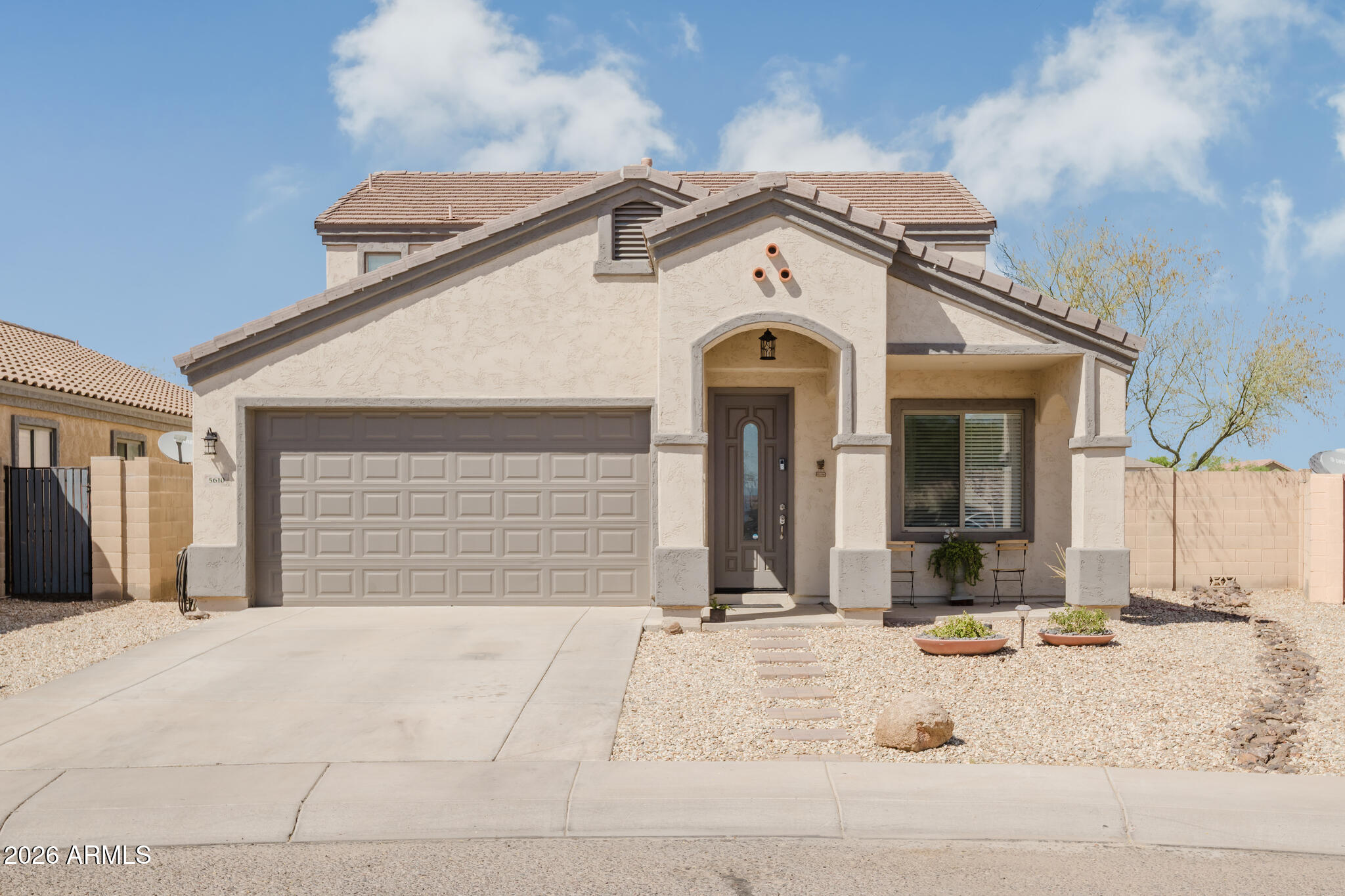 This move-in ready 4-bedroom, 2.5-bath home in Laveen's desirable Cottonfield Ranch offers 2,249 sq ft of comfortable living with a versatile layout featuring separate living and family rooms, a formal dining area, and an upstairs loft ideal for a home office or media space. The downstairs primary suite provides added privacy, while the bright kitchen with stainless steel appliances opens to a spacious living area with high ceilings. Fresh interior and exterior paint add a modern touch throughout. Step outside to a low-maintenance backyard with a covered patio and peaceful views, perfect for relaxing or entertaining. Conveniently located near Loop 202, shopping, dining, and schools. This home combines space, style, and an ideal location.