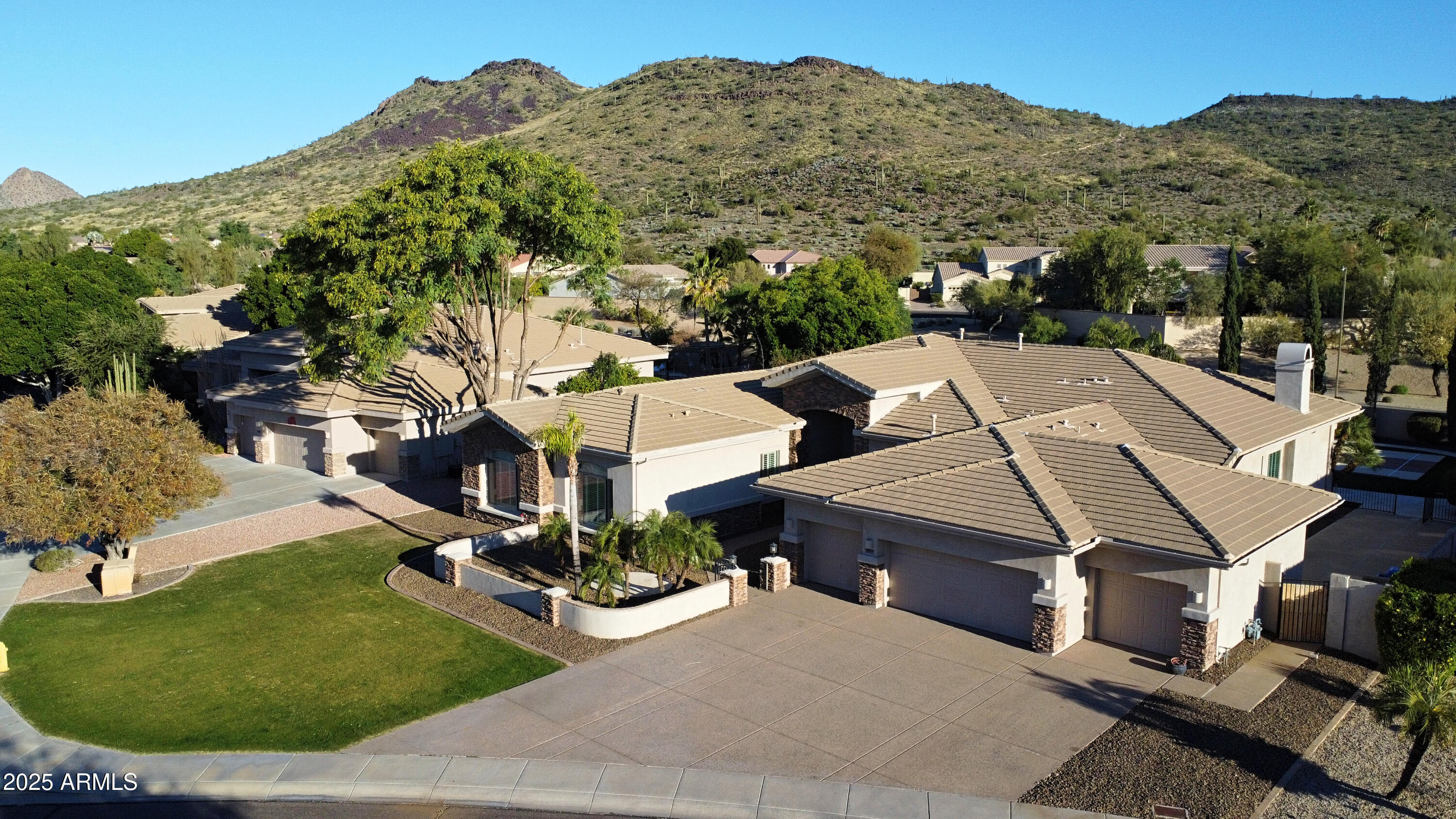 **NOW LISTED BELOW APPRAISAL!** A rare opportunity in Stetson Hills, this semi-custom estate offers breathtaking mountain views, a unique floorplan, and exceptional versatility for multi-generational living. Set on nearly half an acre, the home features a finished basement with expansive living space and additional bedrooms, ideal for guests, extended family, or flexible use.The main level showcases the master suite and multiple ensuite bedrooms, while a distinct west-wing addition creates privacy and functionality rarely found in homes of this size. Thoughtful design details include plantation shutters, crown molding, wet bar, and quality finishes throughout. Notice the four car garage, stone accents, lush green grass, and impressive courtyard, offering stunning curb appeal! Read on: Outdoor living is equally impressive and thoughtfully designed to feel like a private resort. The expansive travertine-tiled back patio creates the perfect setting for both large-scale entertaining and everyday relaxation, seamlessly connecting the home to its outdoor amenities. A private courtyard offers a peaceful retreat for morning sips or evening gatherings, while the pool invites you to unwind and enjoy Arizona's year-round sunshine. The built-in BBQ makes hosting effortless, and the pickleball/sport court adds a rare recreational element ideal for active lifestyles, family fun, or friendly competition.
Beyond the property, an exceptional lifestyle continues with miles of walking, biking, and hiking paths beginning directly across the street, providing immediate access to the surrounding desert landscape and mountain views without ever needing to get in the car. Despite the tranquil, hillside setting, the home remains just minutes from I-17, offering convenient access to dining, coffee shops, fitness studios, and everyday shopping. This remarkable residence delivers a rare combination of space, privacy, recreation, and connectivity, an opportunity to enjoy true resort-style living in one of North Phoenix's most desirable hillside communities. Hurry!