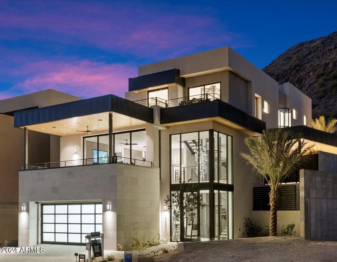 Bring Your Buyer's Offer! The One & Only Move-In Ready Now with Unobstructed Views Of Camelback Mountain! New Construction & Never Occupied! This magnificent property showcases the finest custom finishes & details throughout!  This home features 4 bedrooms, 2 den, 4.5 baths, 4,604 SF, including a 3-car tandem garage. Walls of glass and exquisite lighting exhibit the beauty of all the rooms of this stunning home. The impressive entry provides both an elevator and stairwell leading you to the upper levels. While on the main living level, take in the captivating city views. The living room encompasses style and comfort with an exceptional sleek design fireplace, accompanied with glass shelves for your favorite accessories. The main kitchen provides custom cabinetry with ample storage, an additional hidden prep sink, top of the line
appliances, invisacook induction cooktop which is seamlessly built in the kitchen island, and a substantial walk-in pantry. Adjacent is a private dining room with views to a beautiful outdoor water feature on one side and the other side displaying a 366-wine bottle (temperature controlled) illuminated custom glass cabinet. Enjoy your private moments and entertaining times from multiple
patio areas on all the levels of this stunning and one-of-a-kind custom home. Each of the rooms feature a special view. The primary bedroom provides a wonderful bath area, two separate commode rooms, a large walk-in closet with its own washer/dryer/steamer and secret/safe room. From the main bedroom you have a dramatic, unobstructed backdrop of Camelback Mountain. This is the only home of its floor plan featuring two additional rooms as a den/office, meditation or speak easy room. Don't miss the opportunity to own this one and only, move-in ready (furnished or unfurnished), prime location and premium lot... located within the Iconic Phoenician Resort at The Estates at Ascent!