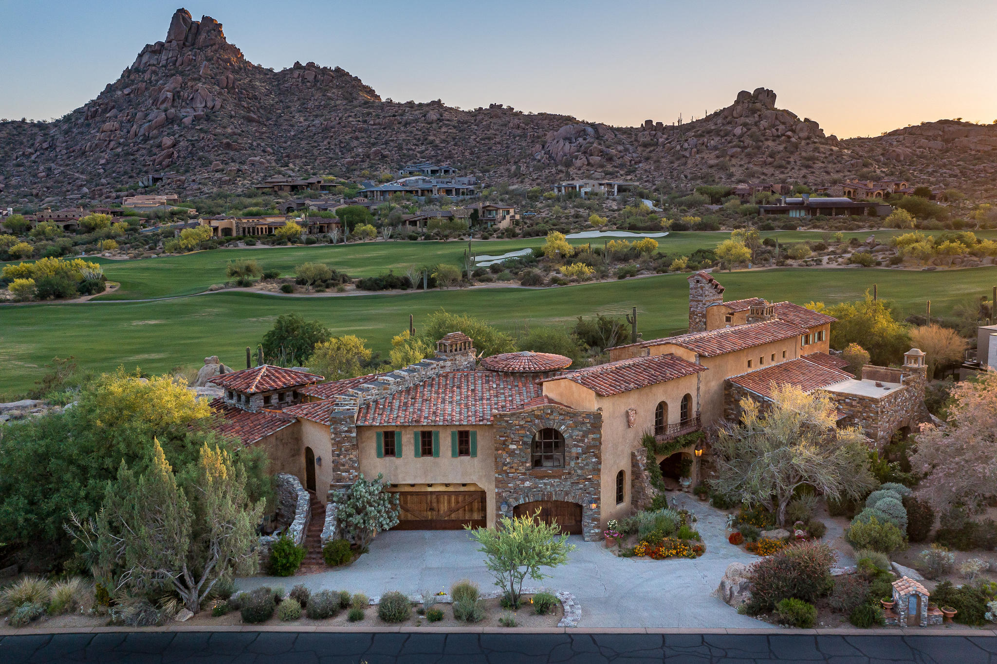 Mediterranean-inspired villa located in the private community of Estancia * Sited on one of the finest lots within the gates, offering dramatic boulder outcroppings and commanding views of Pinnacle Peak, the golf course and west-setting sun * Designed by Allen Tafoya, built by R-Net Construction and interiors by Billy Springer * Extensive use of imported materials to create a true Italian masterpiece * Oversized great room with kitchen, family room, breakfast room and formal dining working seamlessly together * Separate owner's suite with access to private patio and jacuzzi * Guest wing complete with family room and dual suites with access to the back patio * Upstairs office with cozy fireplace and patio overlooking the golf course and Pinnacle Peak * Outdoor living characterized by