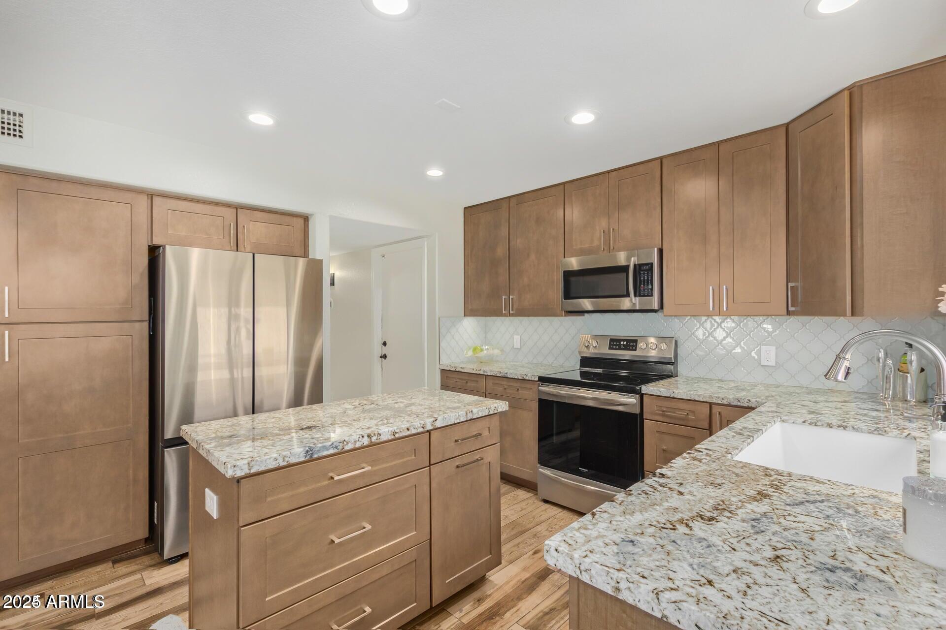This premium corner-lot home checks all the boxes — 4 bedrooms, 2.5 baths, and move-in ready comfort in one of Glendale's most sought-after communities. Step into a bright, welcoming layout featuring a spacious family room, living room, and a versatile flex space perfect for a home office or game room.

The kitchen is beautifully updated with abundant cabinetry, generous prep space, and a sleek modern backsplash. Outside, enjoy Arizona living at its best — a gated pool and spa, built-in BBQ, and even a pool table for sipping summer drinks under the sun. An RV gate adds extra convenience for toys or storage.

Upstairs, the French doors open to a huge primary suite with a private balcony overlooking the pool. The modern ensuite bath features a soaking tub filled with natural light  your personal retreat after a long day.

With upgraded window treatments throughout, 2022 HVACs, and thoughtful touches for home efficiency, this home offers both style and peace of mind. Located minutes from top-rated golf courses, Arrowhead Mall, hospitals, colleges, and the Foothills Recreation & Aquatics Center  you'll love the lifestyle that comes with it.