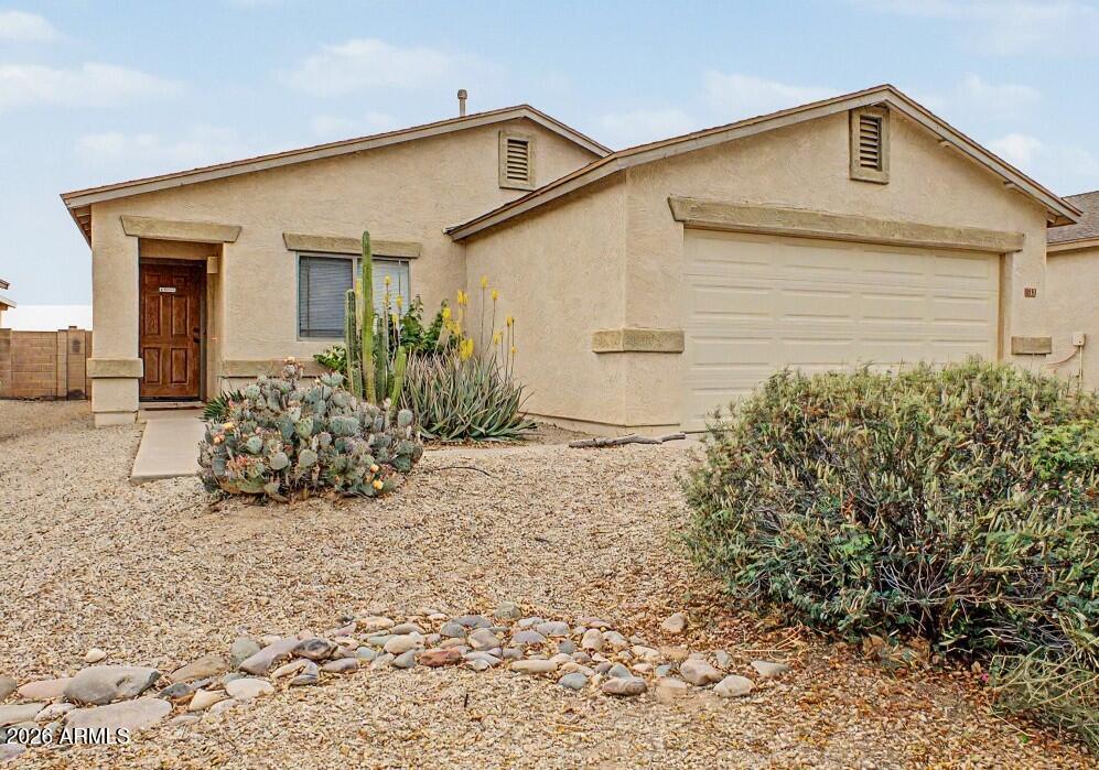This beautifully maintained single-story gem welcomes you with a thoughtful blend of tile flooring and newer carpeting. The kitchen impresses with elegant granite countertops, a spacious pantry, and upgraded maple cabinetry--a premium finish that carries through to both full bathrooms. The private primary suite as well as one of the other well appointed bedrooms, boasts oversized walk-in closets. Step outside to your fully fenced backyard and unwind under the covered patio, where you'll enjoy unobstructed views of Arizona's iconic sunsets. Stroll along beautifully maintained paths that wind through the community pool area, volleyball courts, ponds, pocket parks as well as many other amenities.  Complete with a newer HVAC (2022) and water softener (2023), bringing you piece of mind.